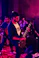 Musician playing electric guitar on stage with band