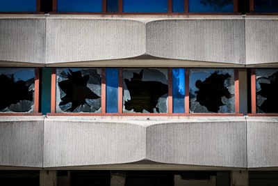 Broken windows on a concrete building facade.