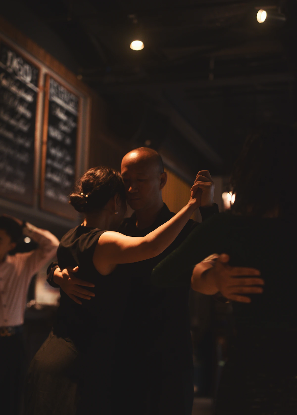 Couple dancing close in a dimly lit room
