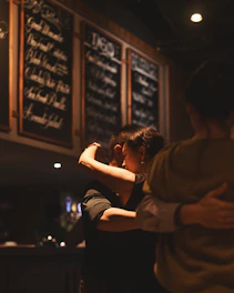 Couple embracing in a dimly lit restaurant