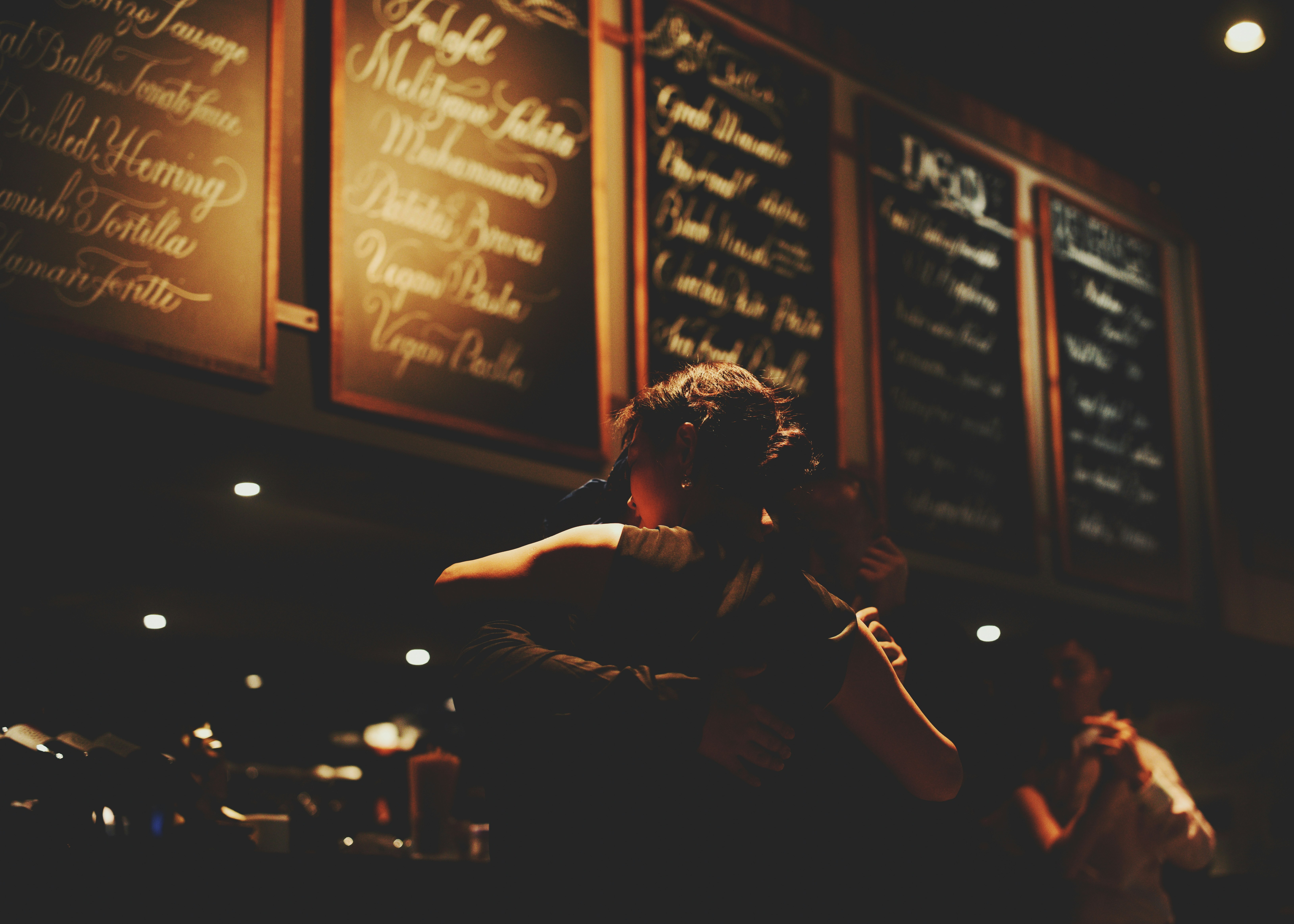 Musician playing violin in dimly lit restaurant
