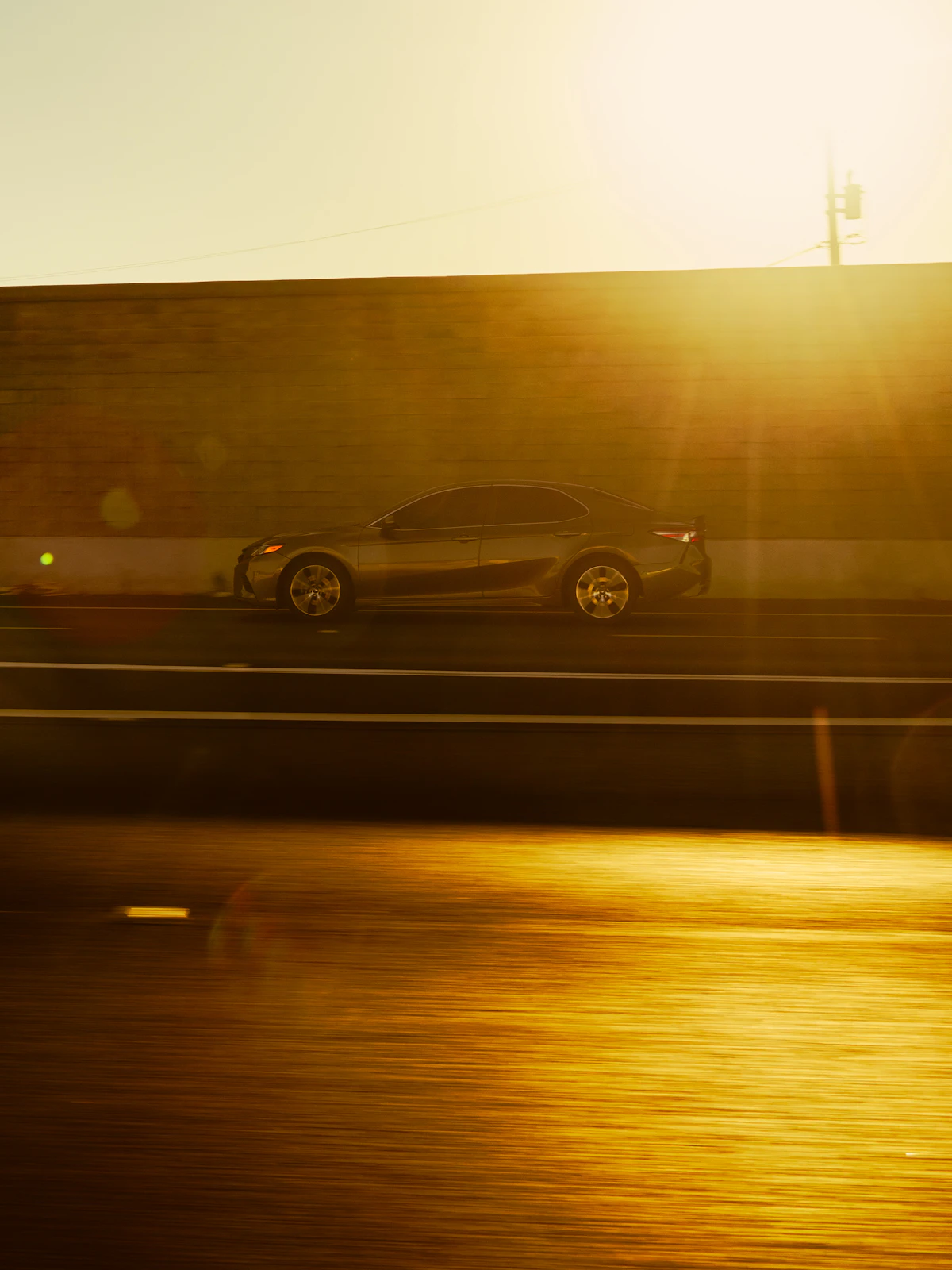 Vehicle travelling on a highway at sunset