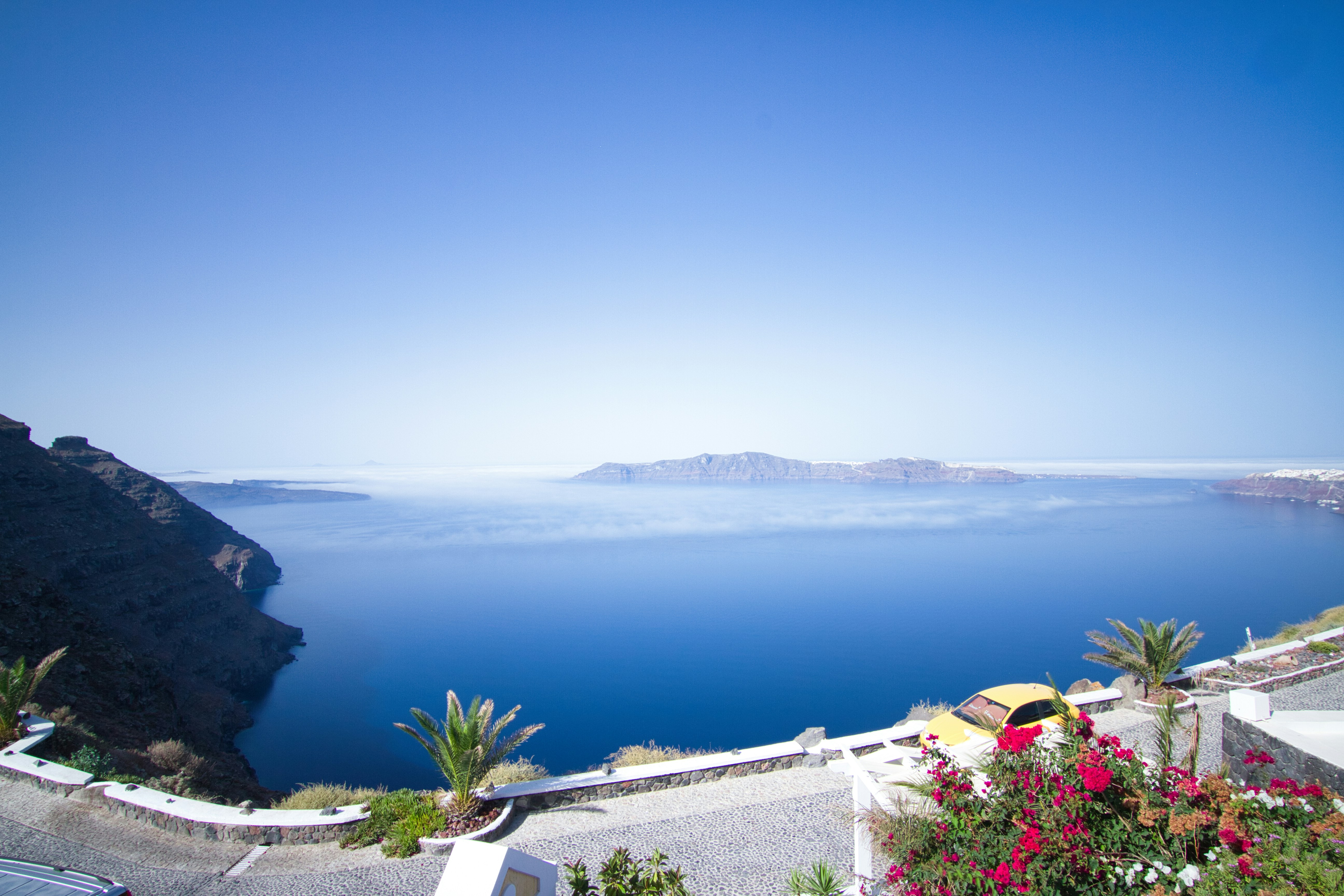 Calm blue ocean with distant islands under clear sky.