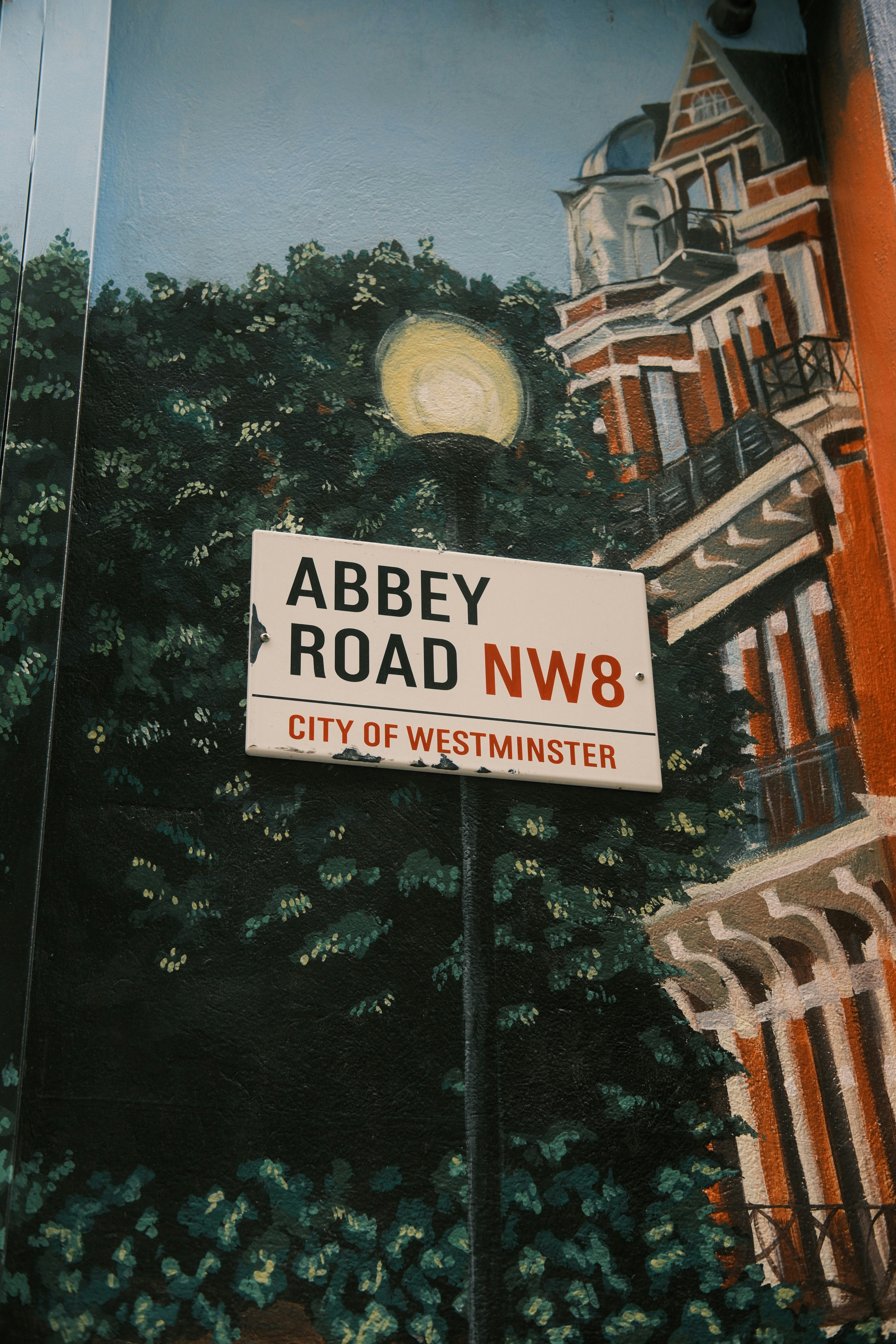 Abbey road street sign in front of painted building