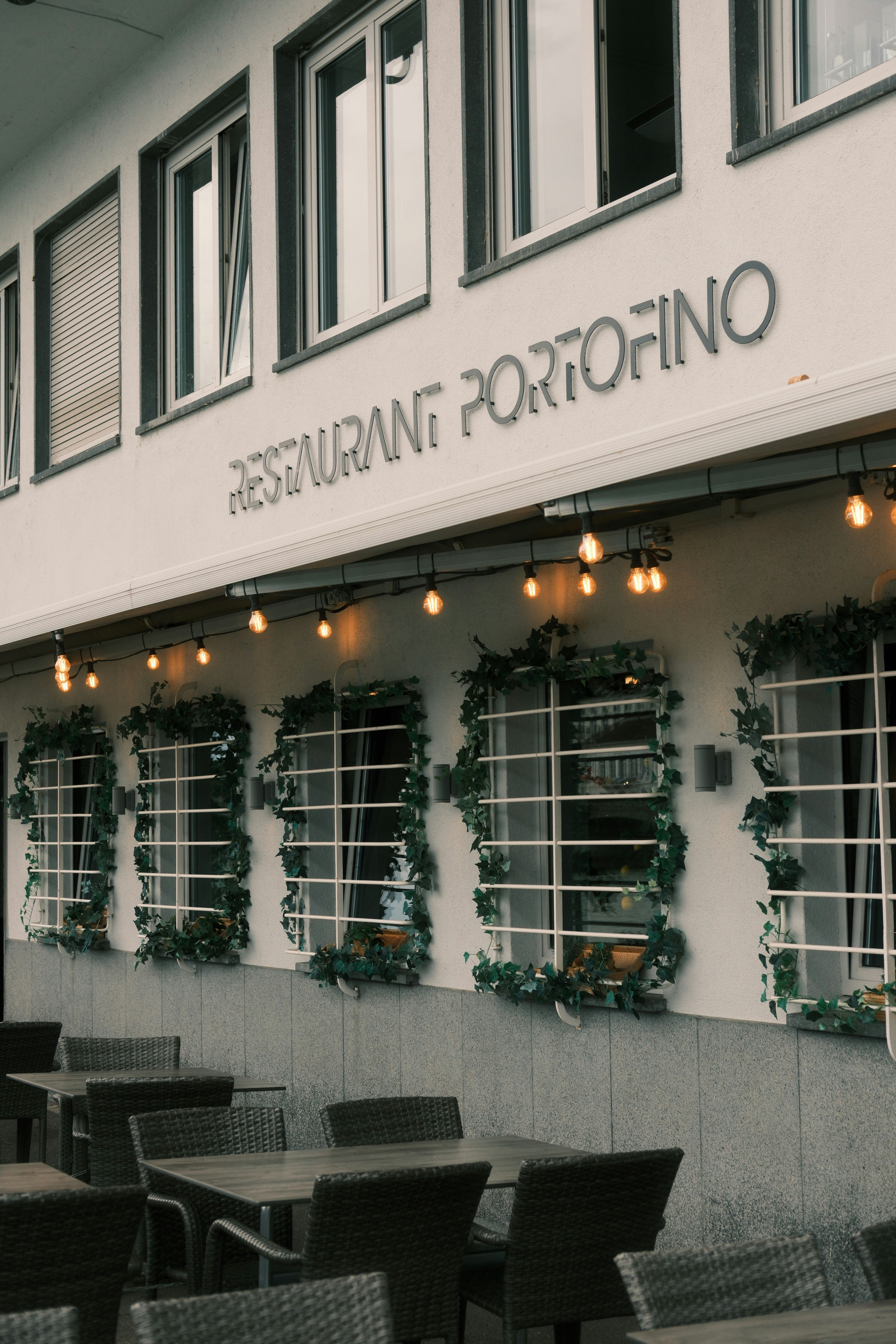 Restaurant portofino with outdoor seating and string lights.