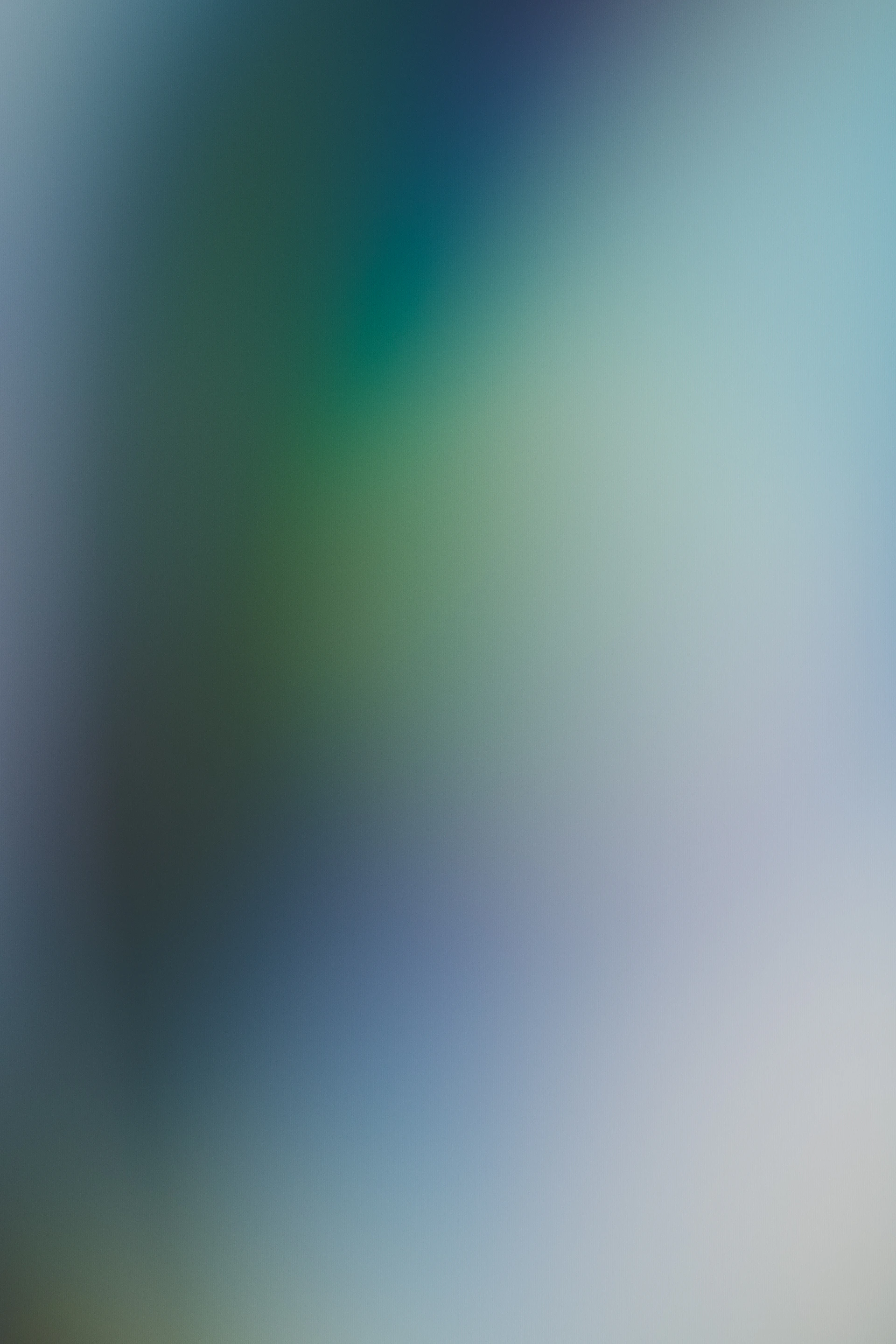 Abstract gradient of blue, green, and white colors.