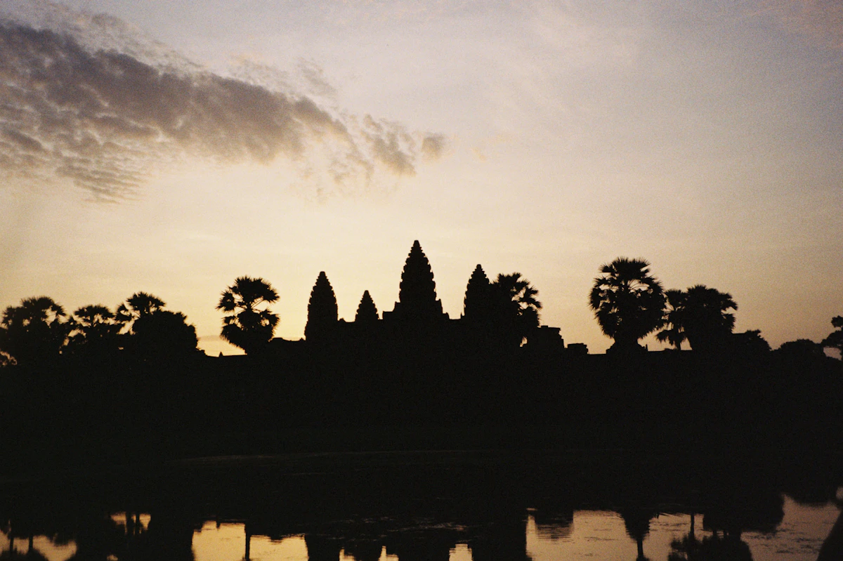 Angkor Wat temple silhouetted against a sunrise sky in Siem Reap, Cambodia