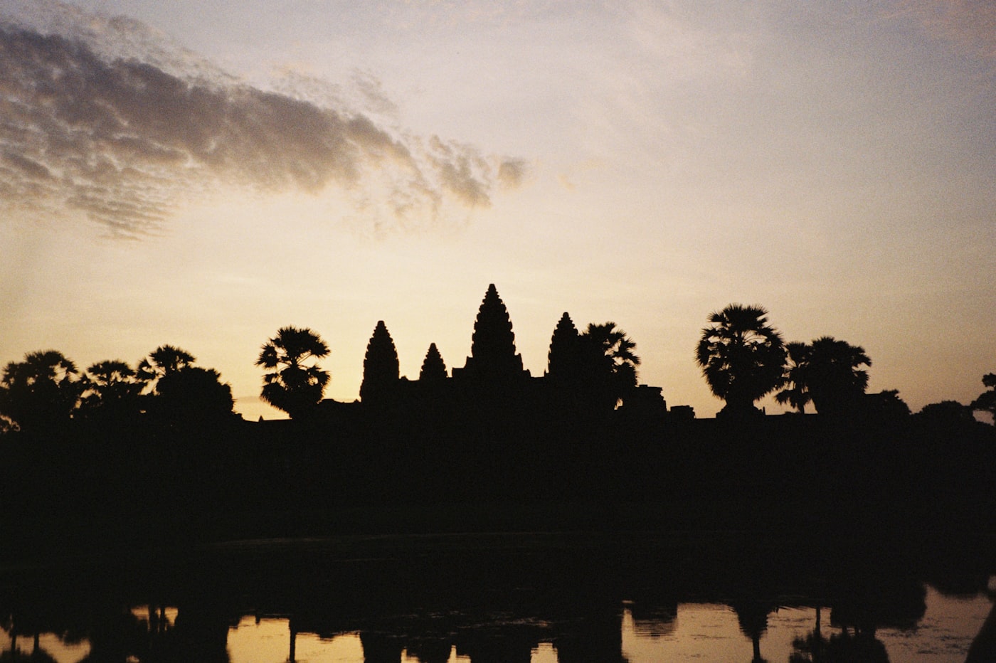 Angkor Wat at dawn — stone corridors, lotus pools reflecting the sky, and the weight of a civilisation held in perfect silence