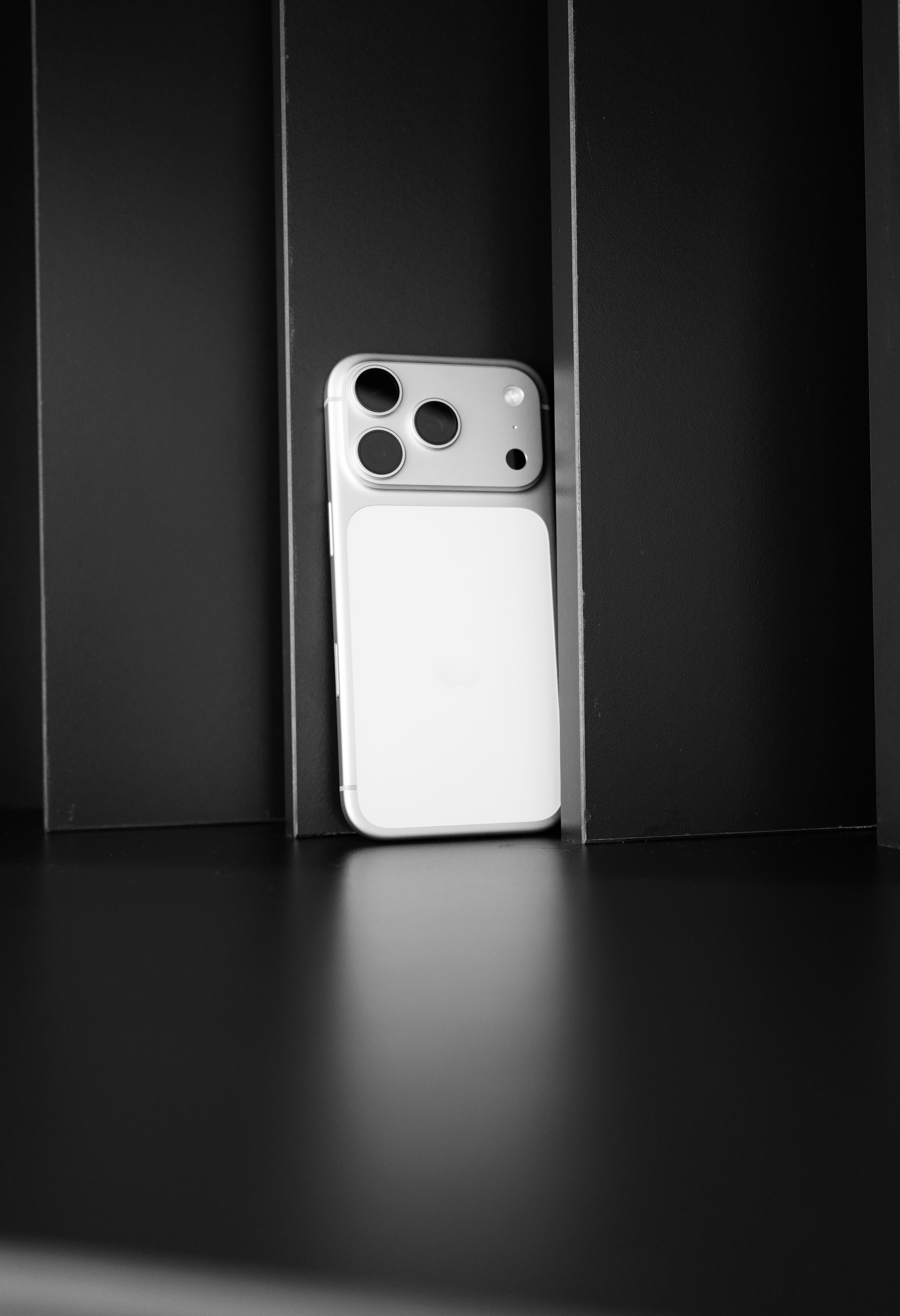 Modern smartphone with triple camera on dark background