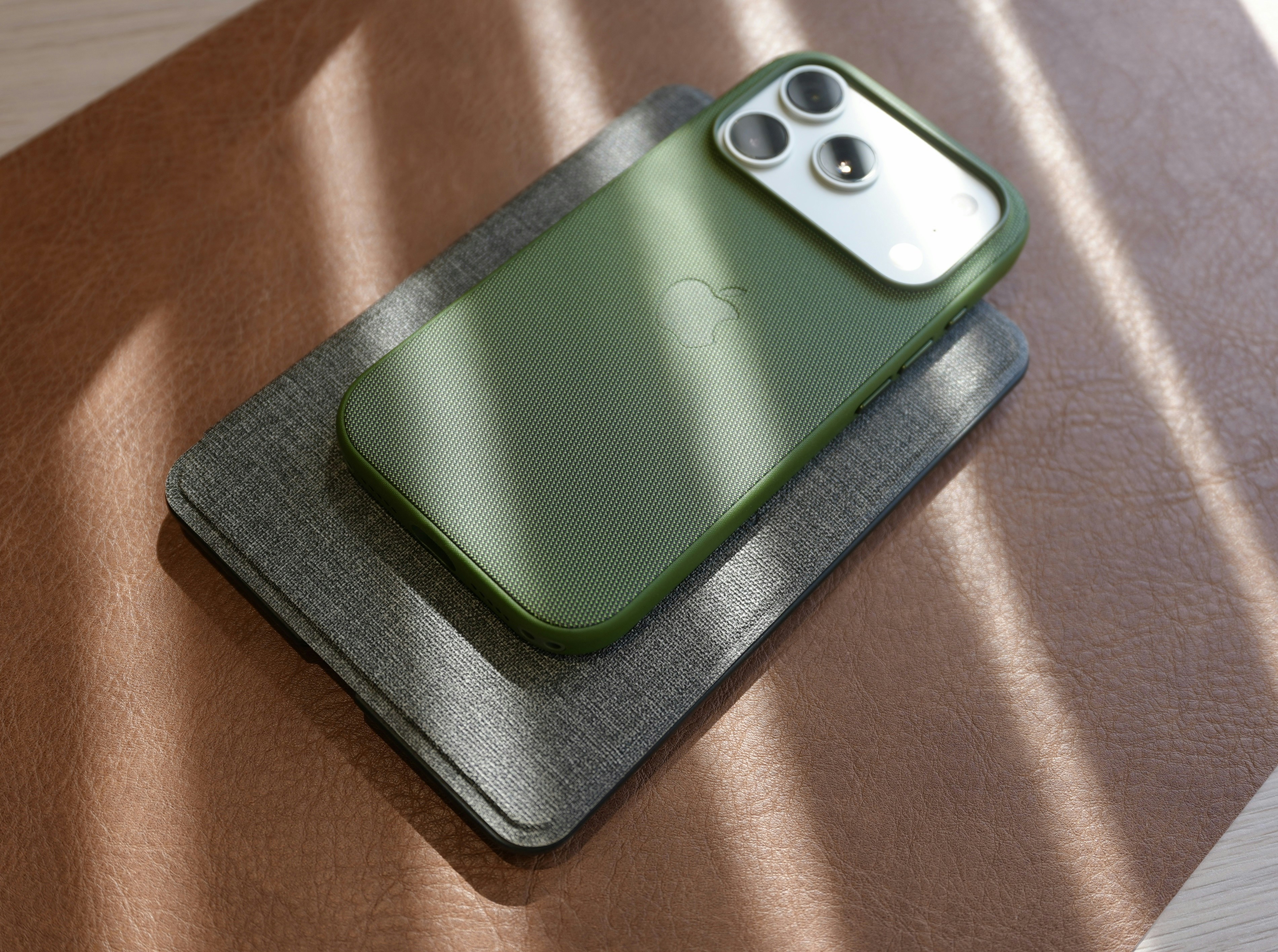 Green smartphone case on a textured surface.