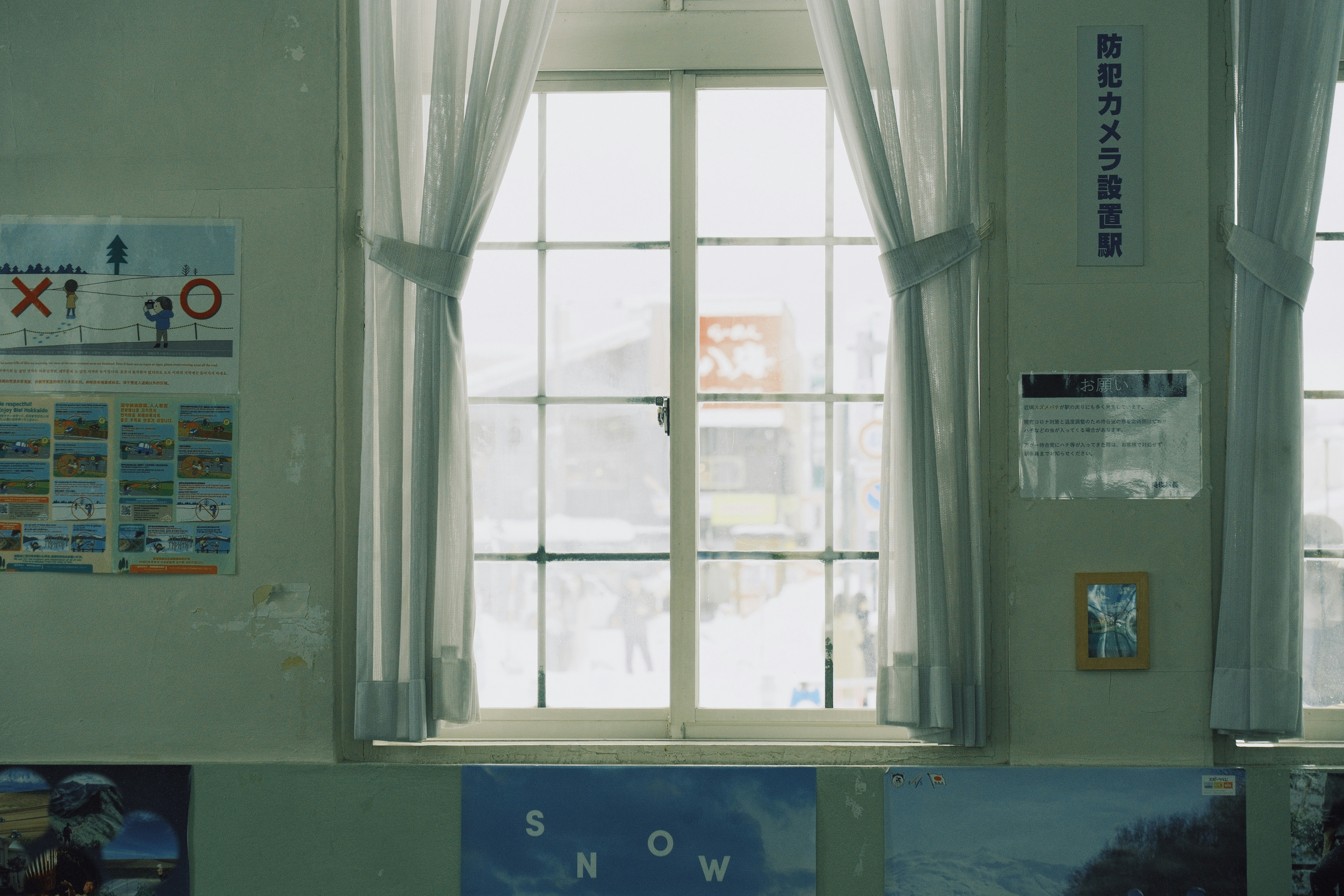 Close-up of a draft stopper being applied to a window frame