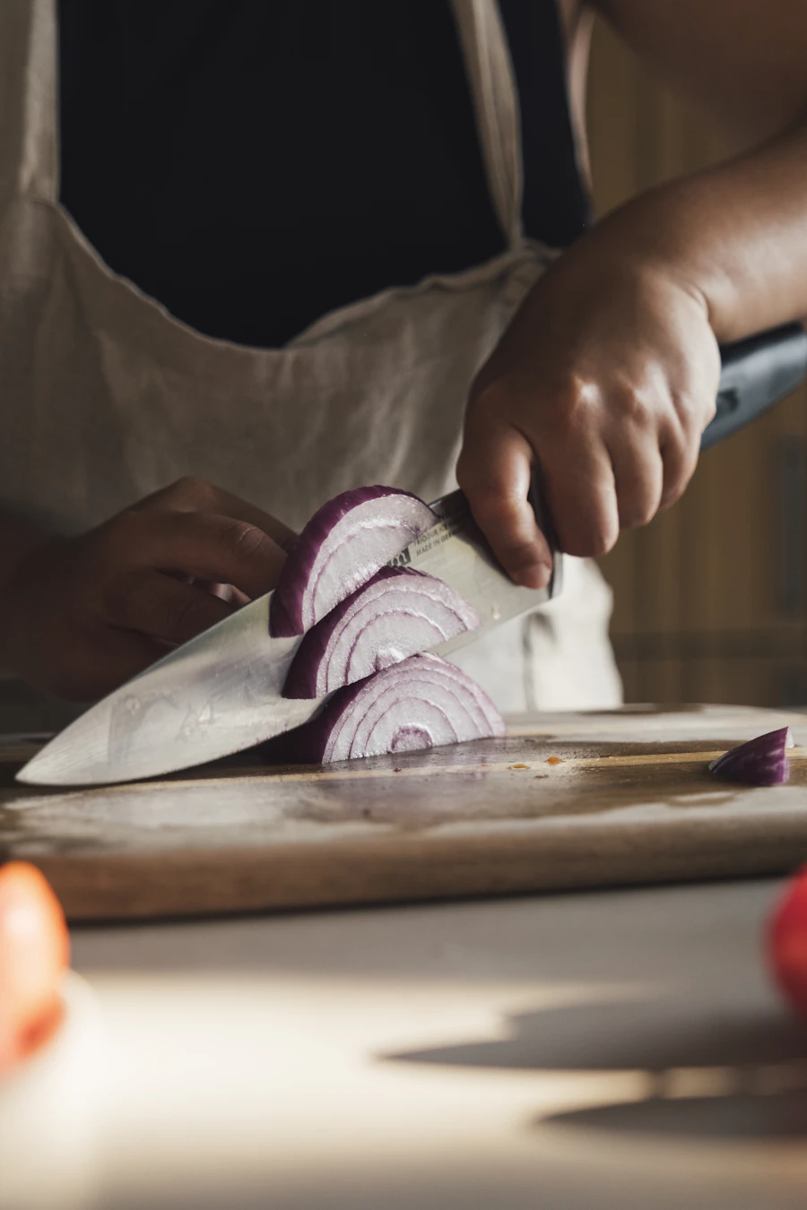 Hands chopping vegetables on a cutting board