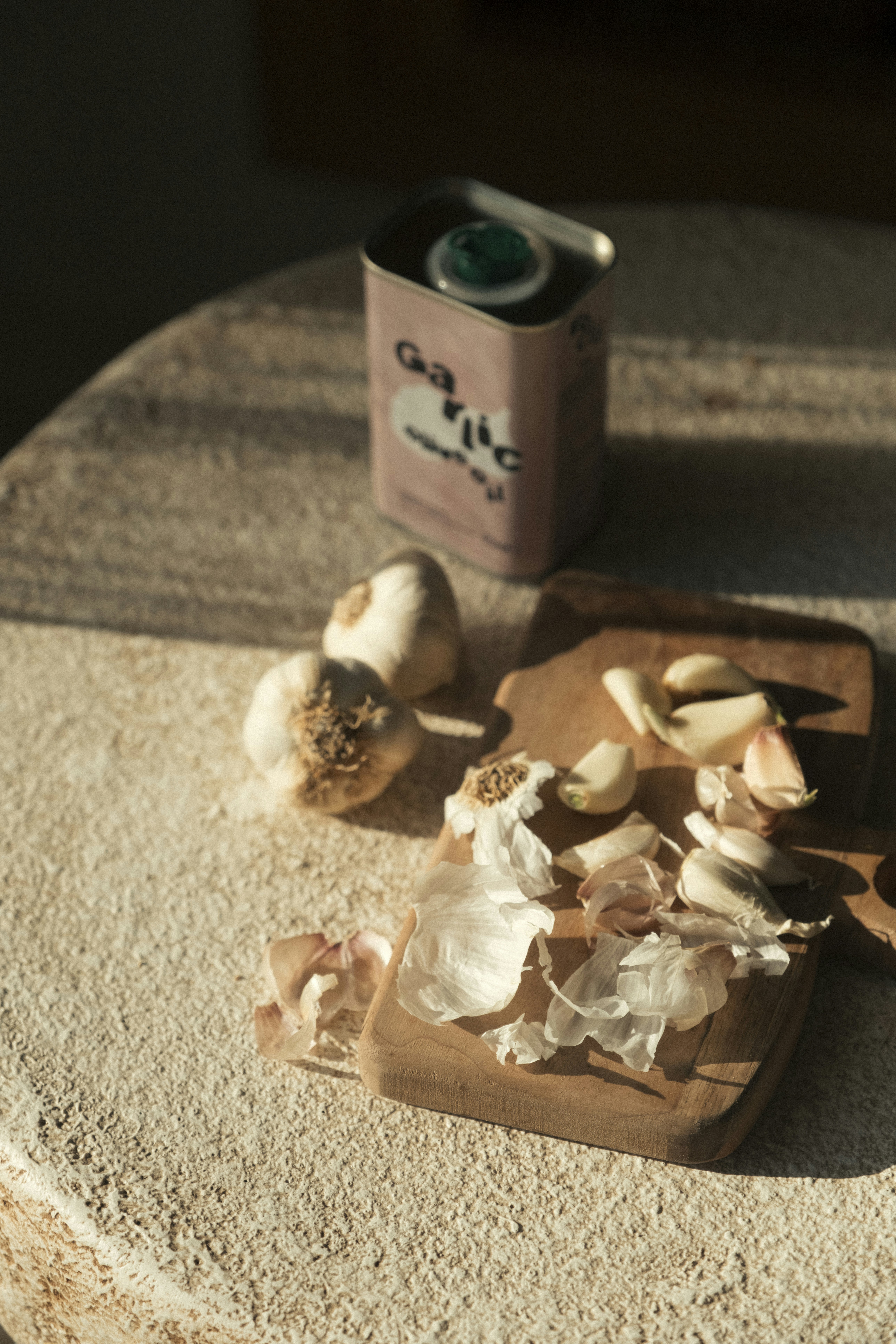 Garlic cloves and bulbs on a wooden cutting board.