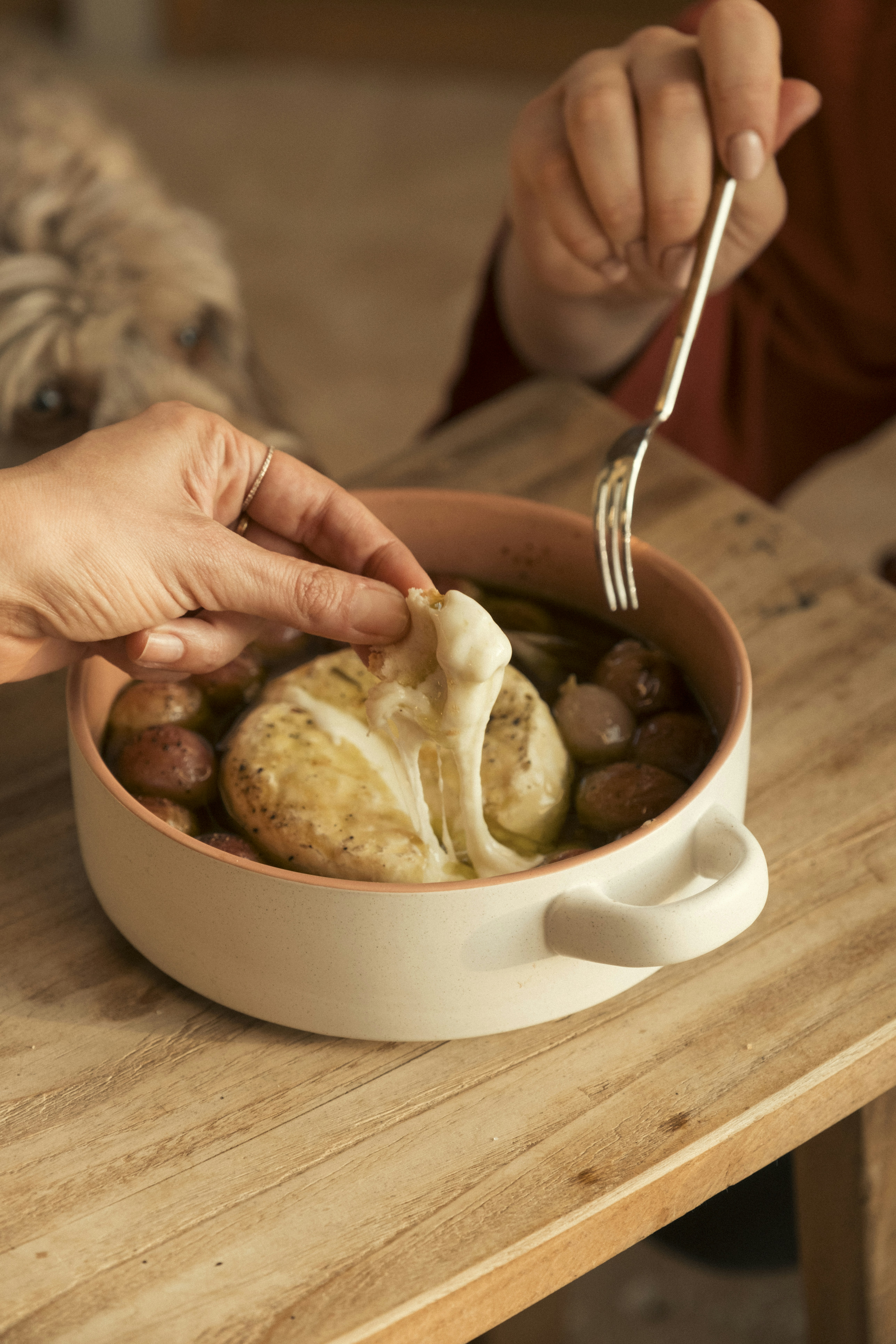 A baked cheese dish with potatoes and herbs
