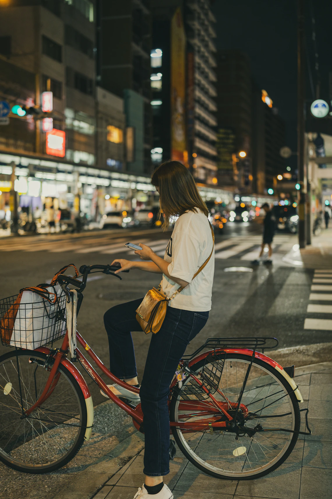 Cyclist riding through a city street at night