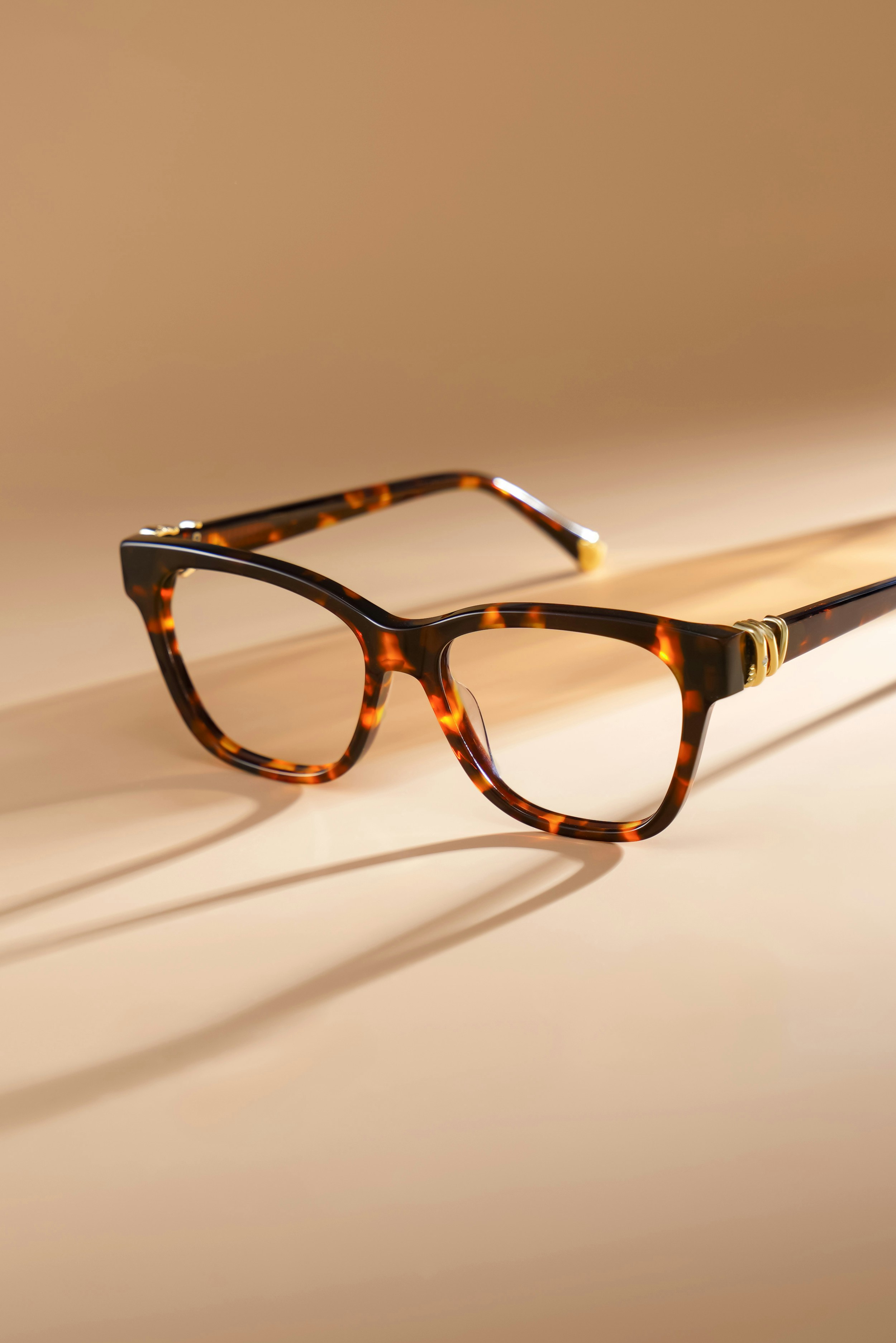 Tortoiseshell eyeglasses on a neutral background