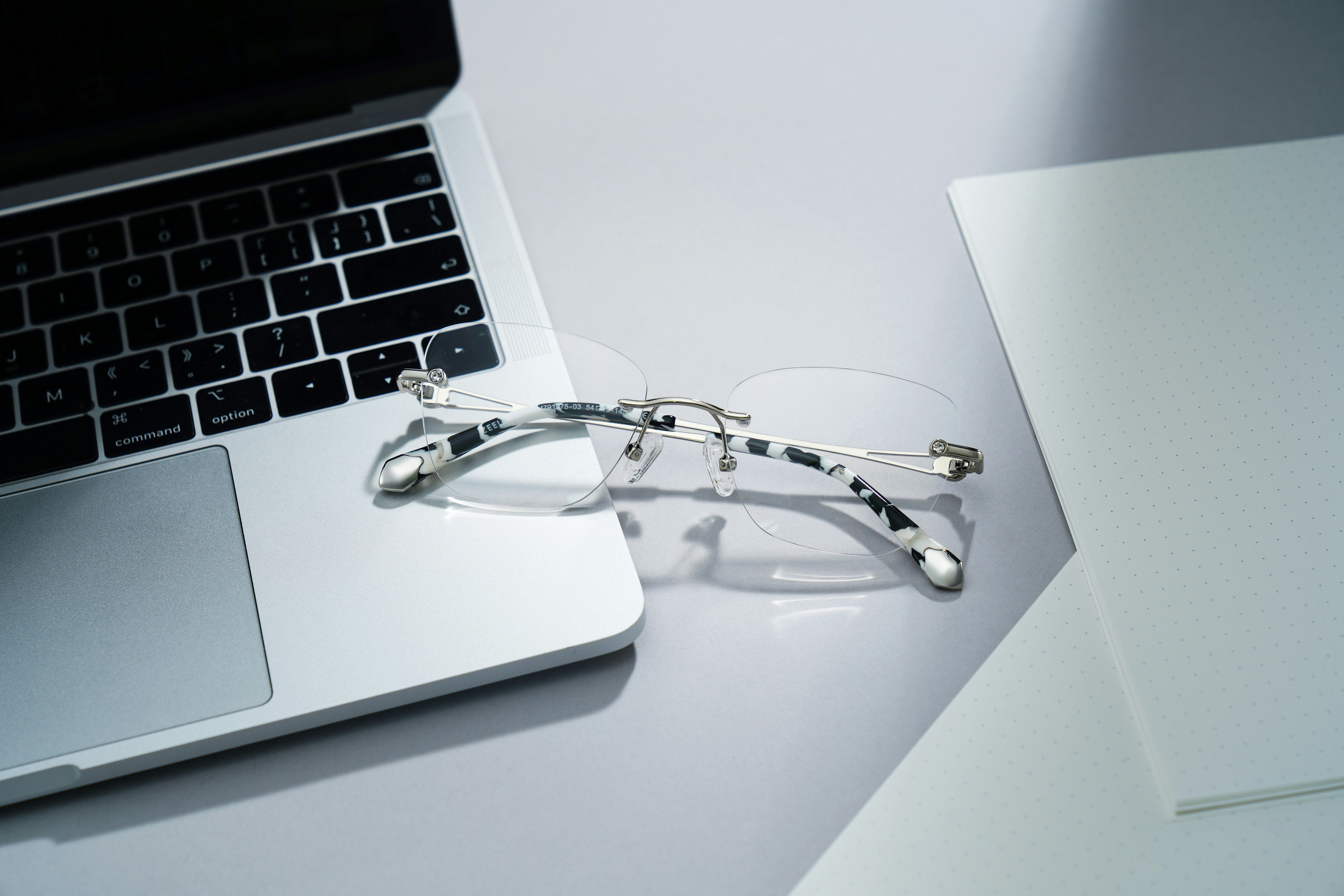 ultrathin silver laptop open on minimalist workspace
