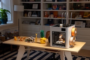 3D printer with filament and printed objects on desk