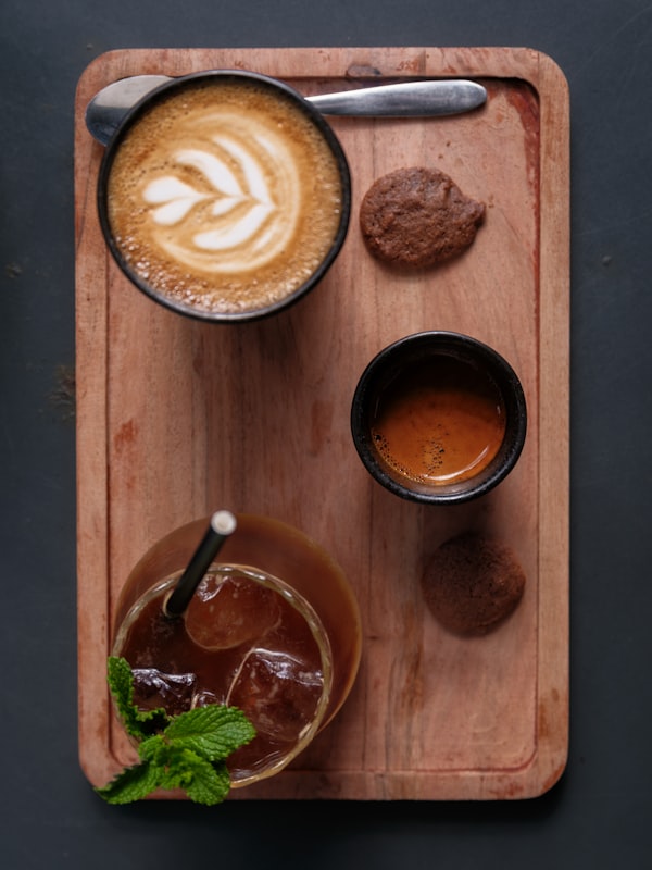 Flat lay of coffee with cookies on a warm tray