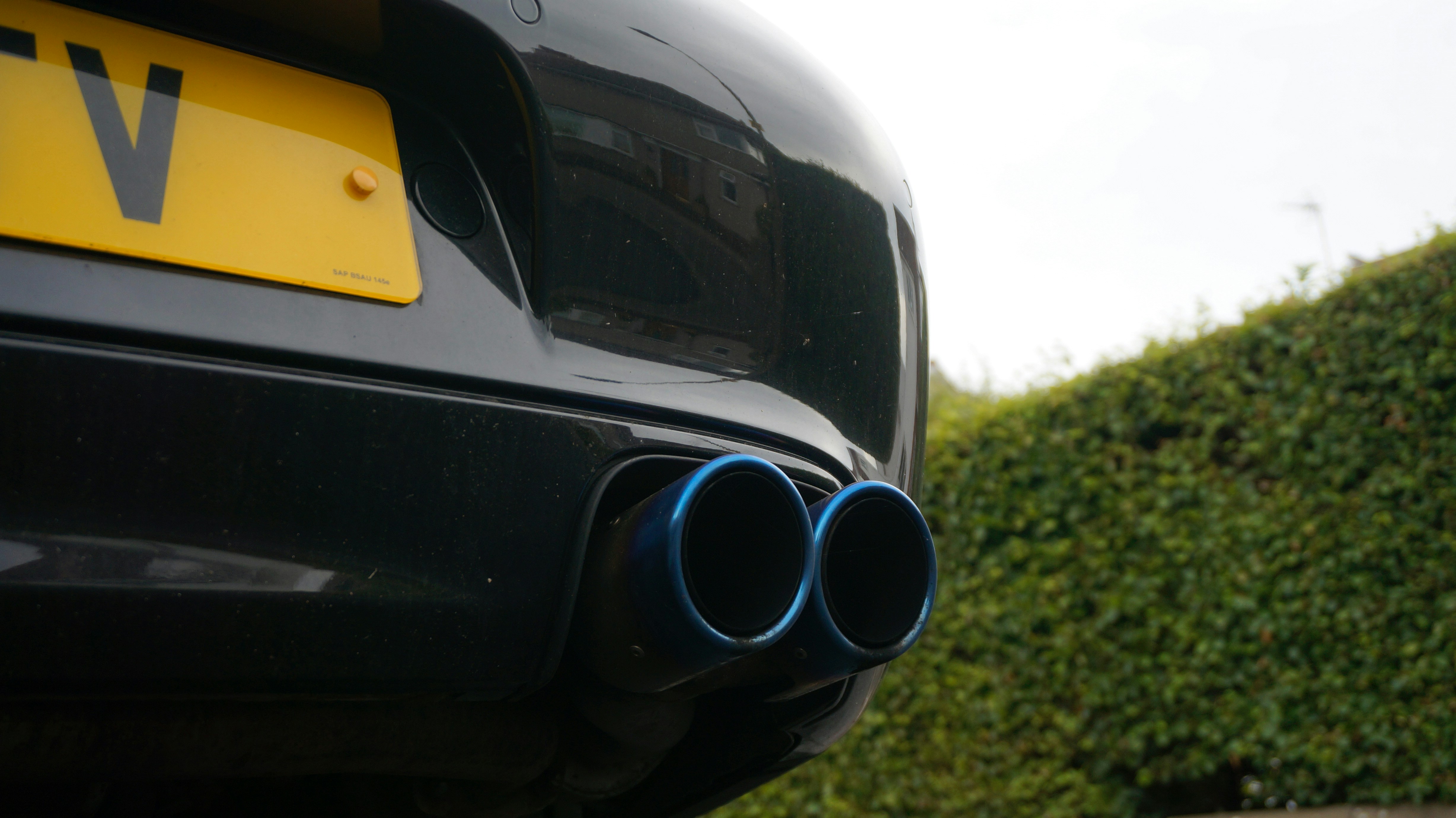 Close-up of blue exhaust pipes on a car.