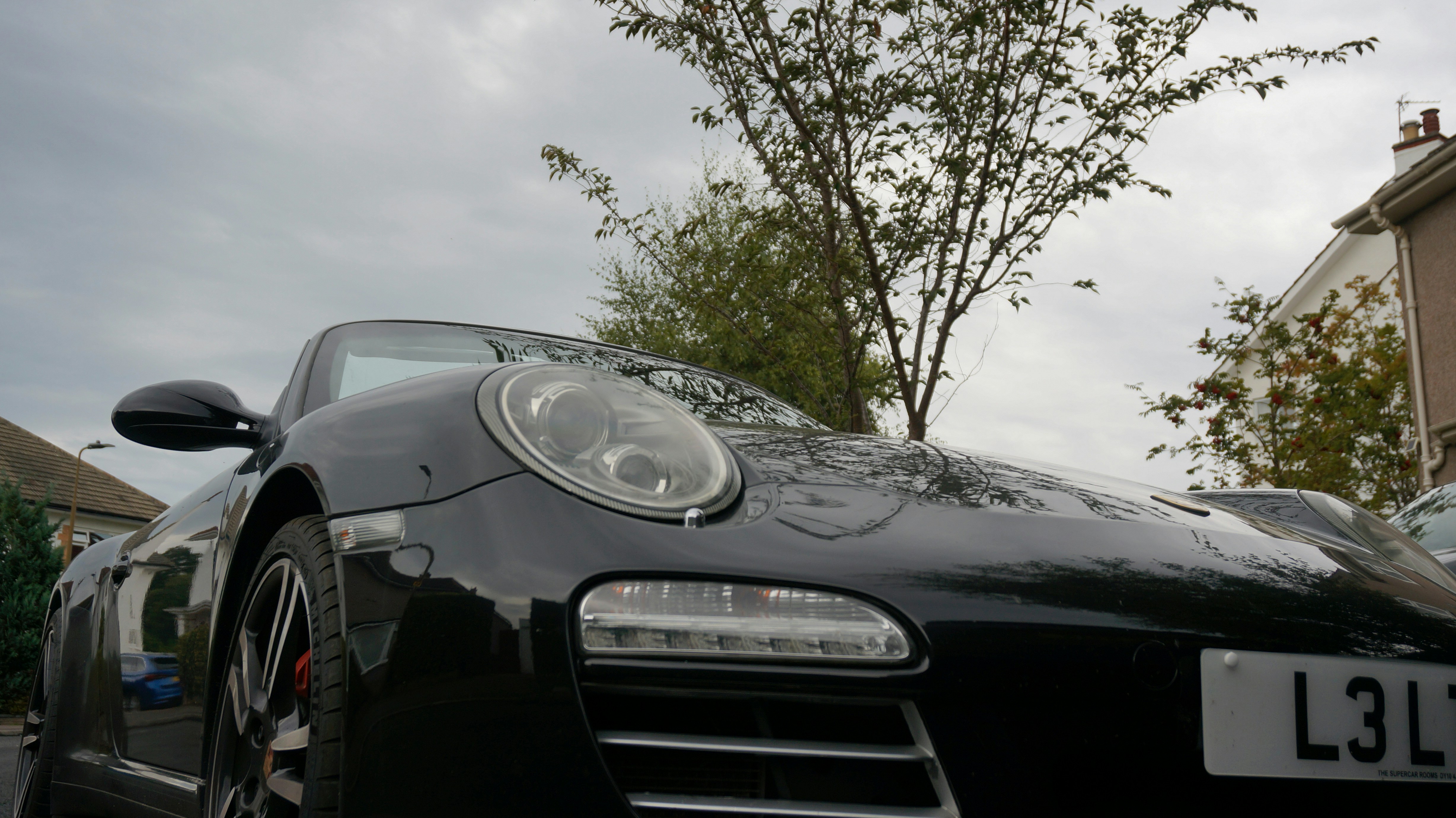 Black porsche car parked on street