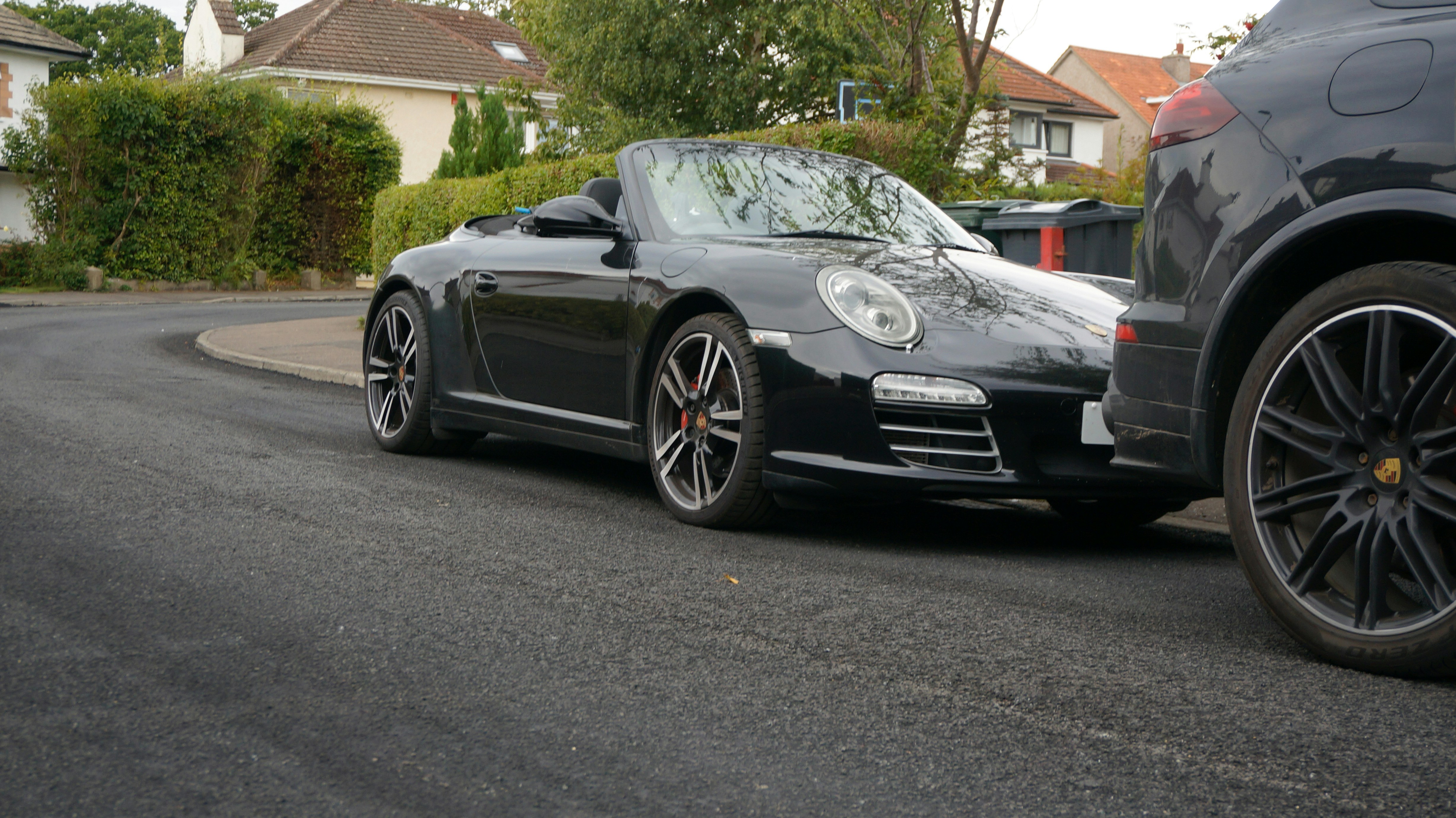 A black convertible sports car parked on street.