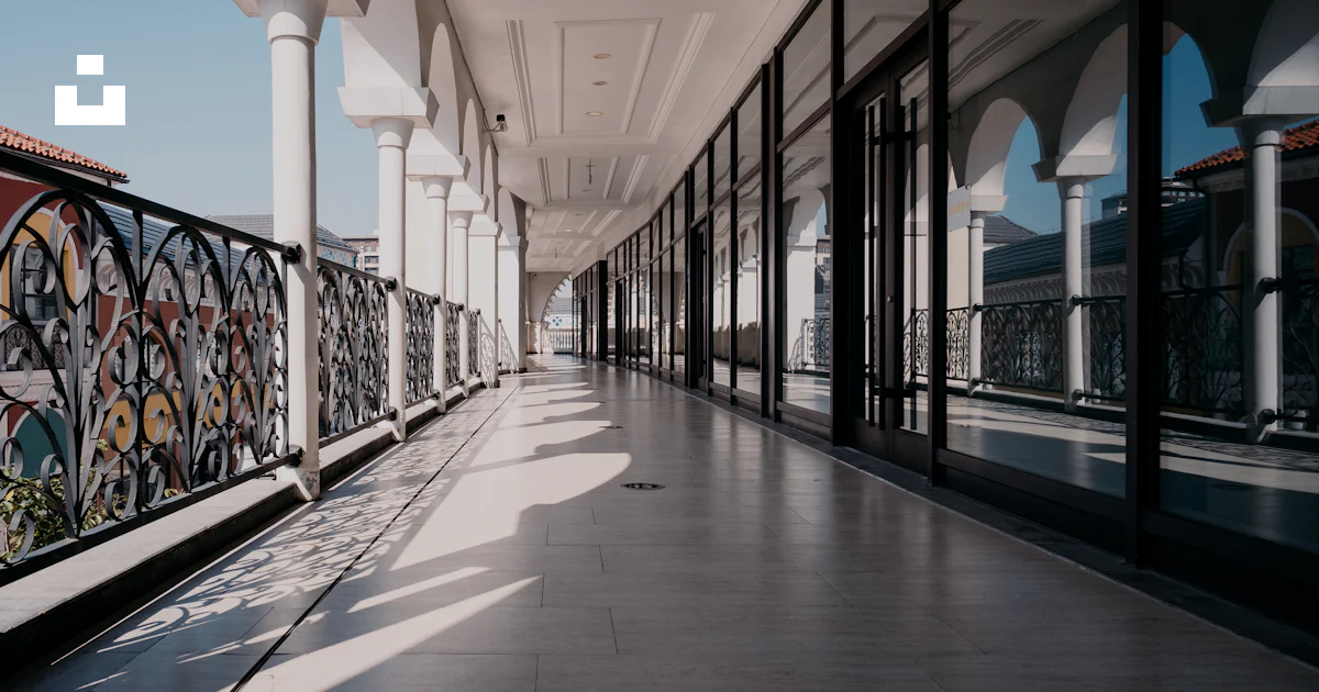 Corridor Using Railing Long white corridor with arched windows and decorative railing photo ...
