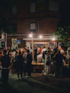 Crowd gathered outside a bar at night