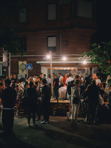 Crowd gathered outside a bar at night