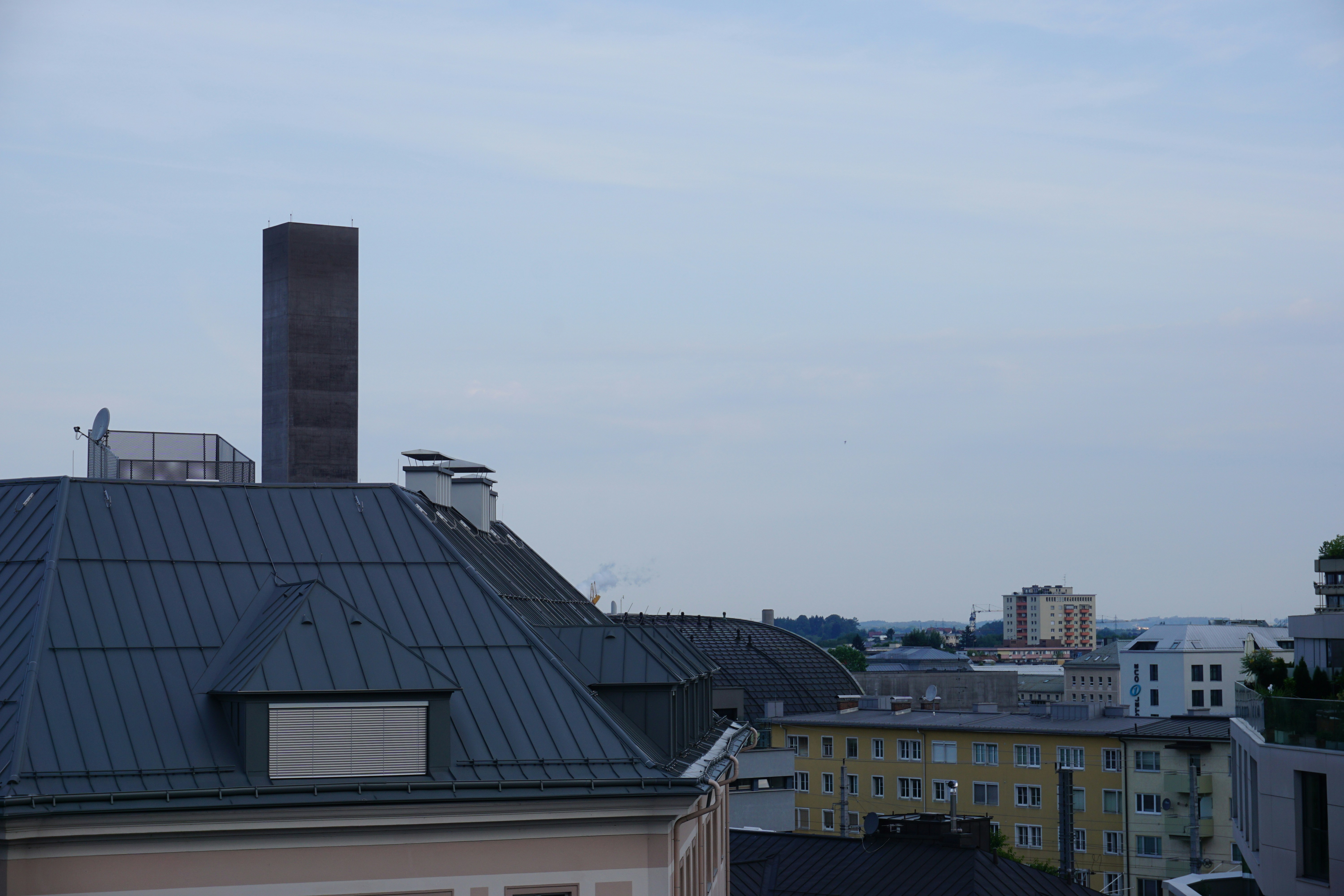Rooftops of buildings under a cloudy sky