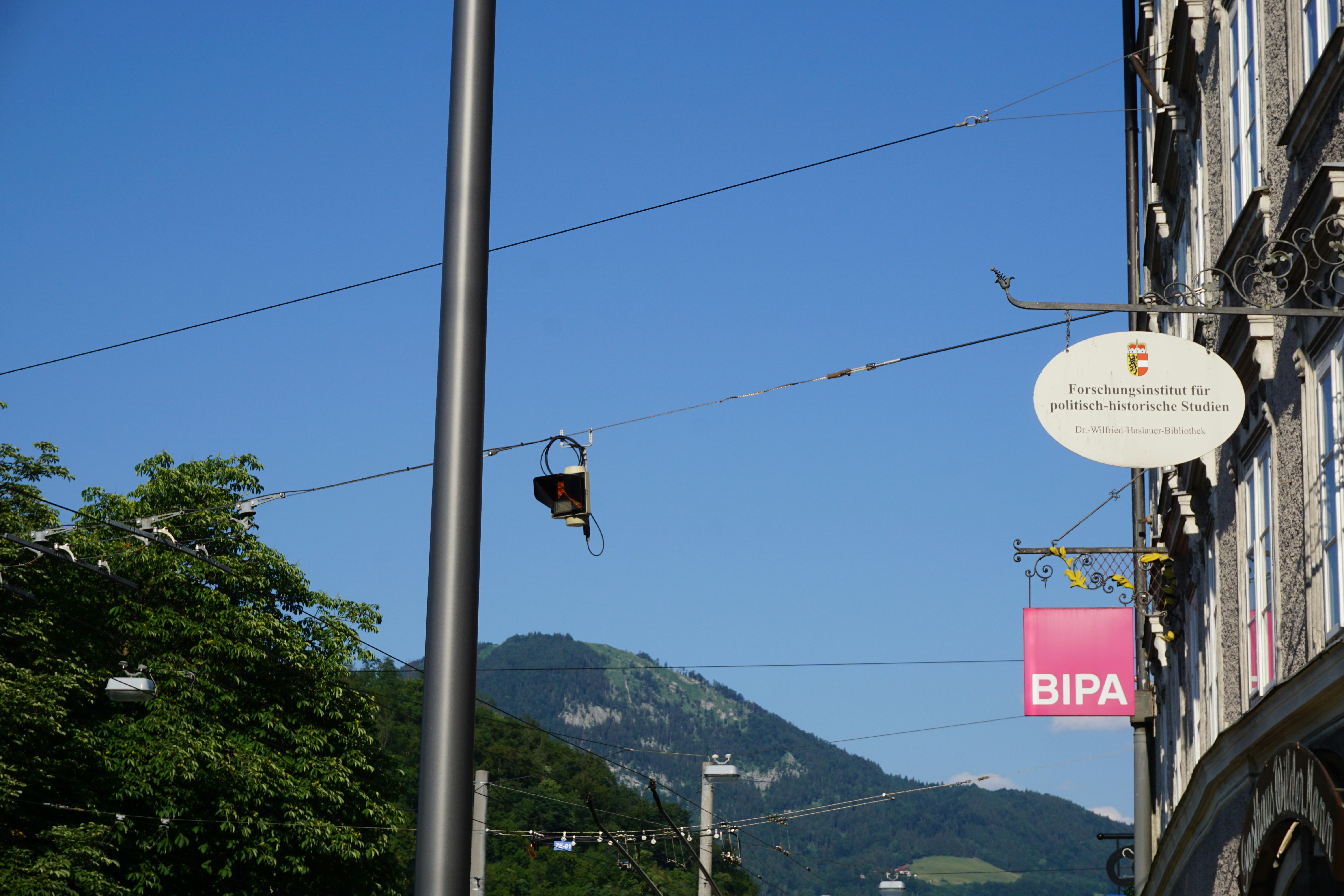 A city street with buildings and mountains.