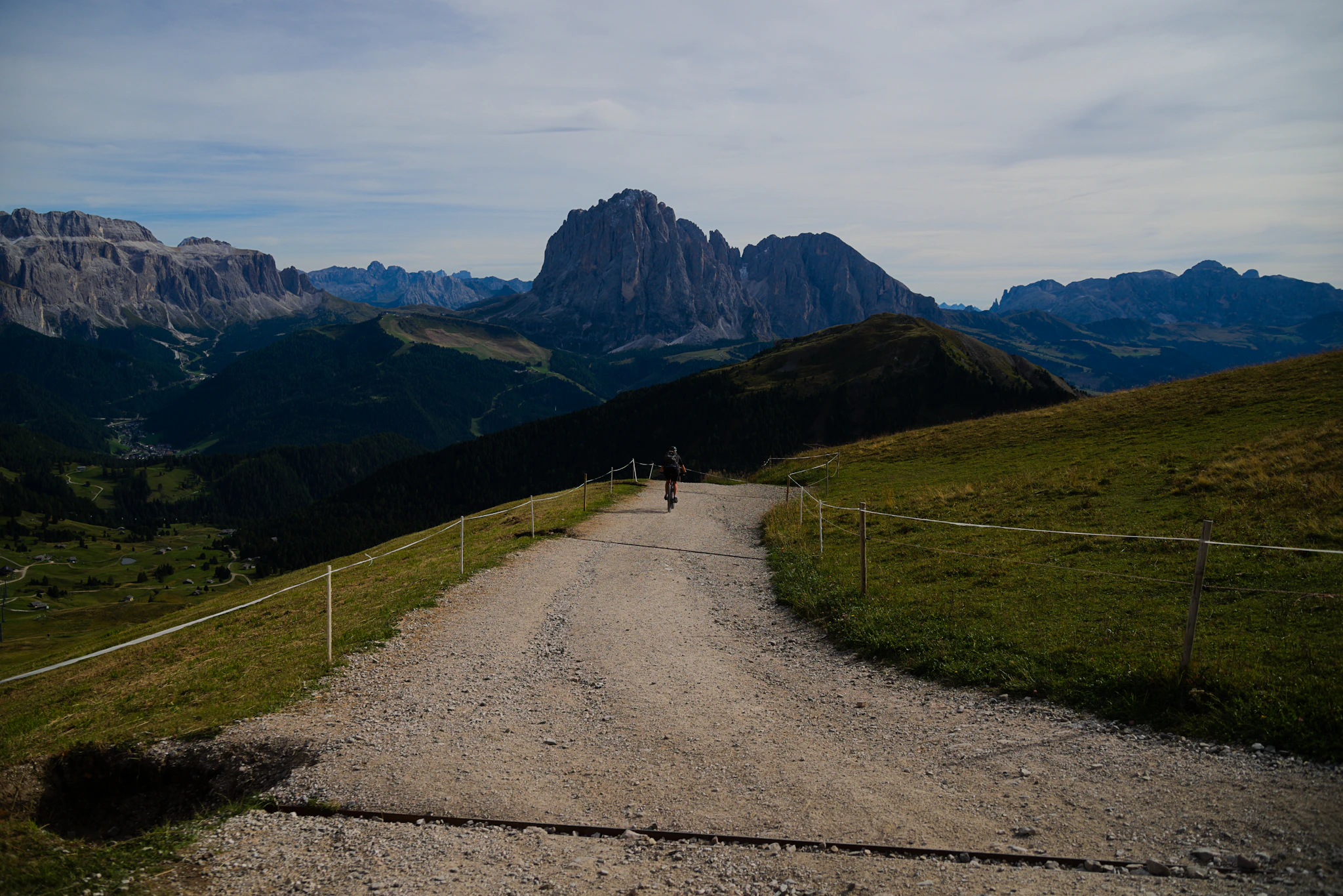 A gravel path leading towards the Seceda peaks, a classic stage of Dolomites walking holidays