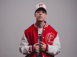 Young man in baseball cap and varsity jacket