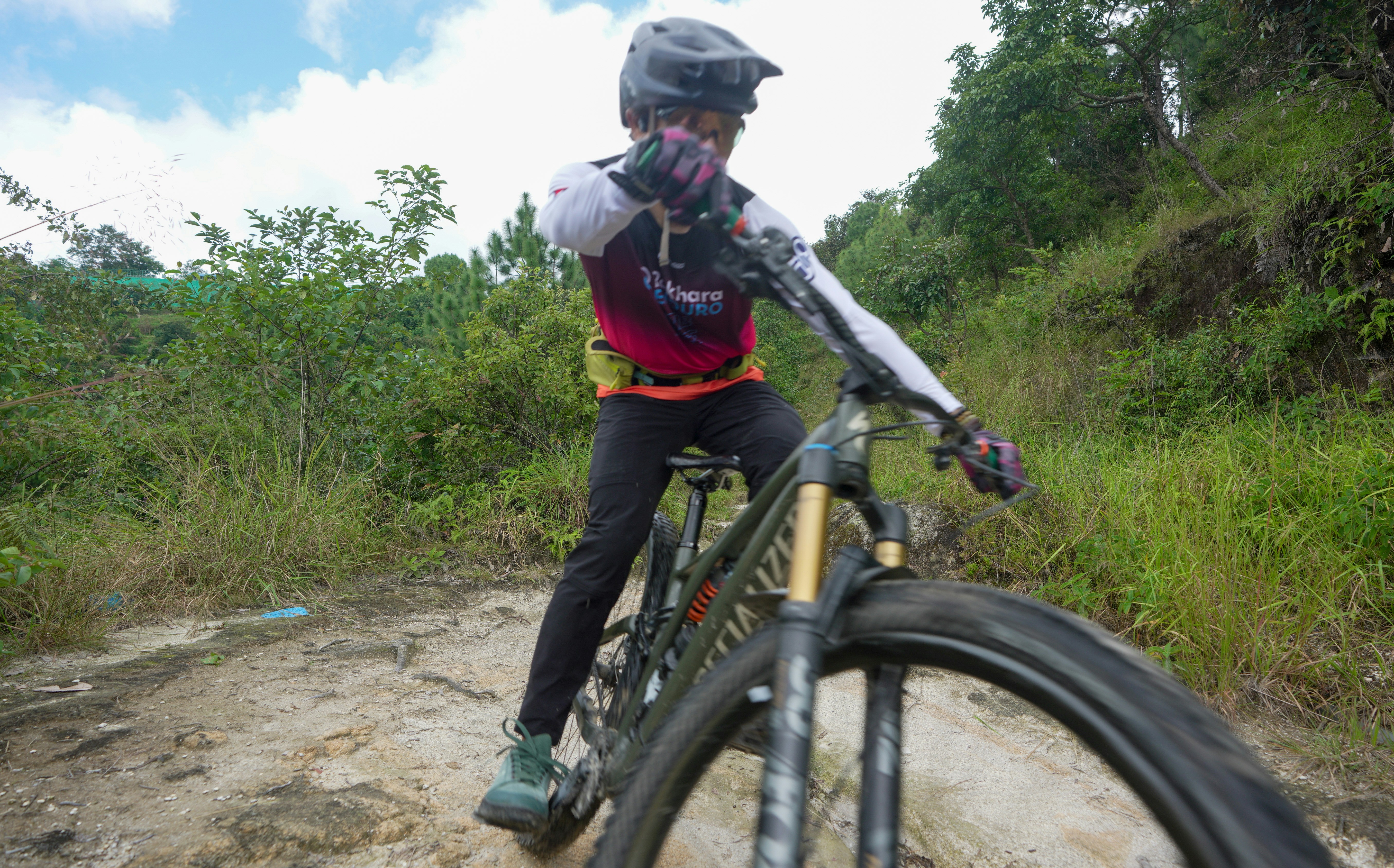 Mountain biker riding on a dirt trail