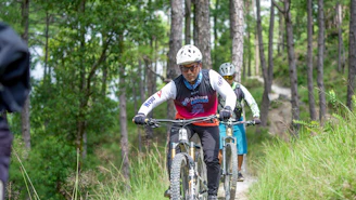 Cyclists riding mountain bikes on a forest trail