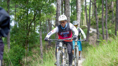 Cyclists riding mountain bikes on a forest trail