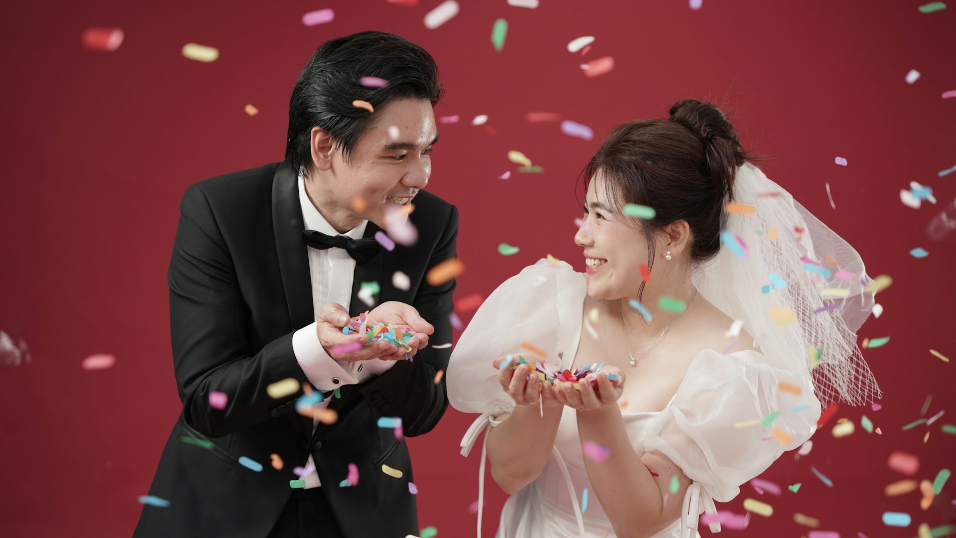 Bride and groom celebrating with confetti