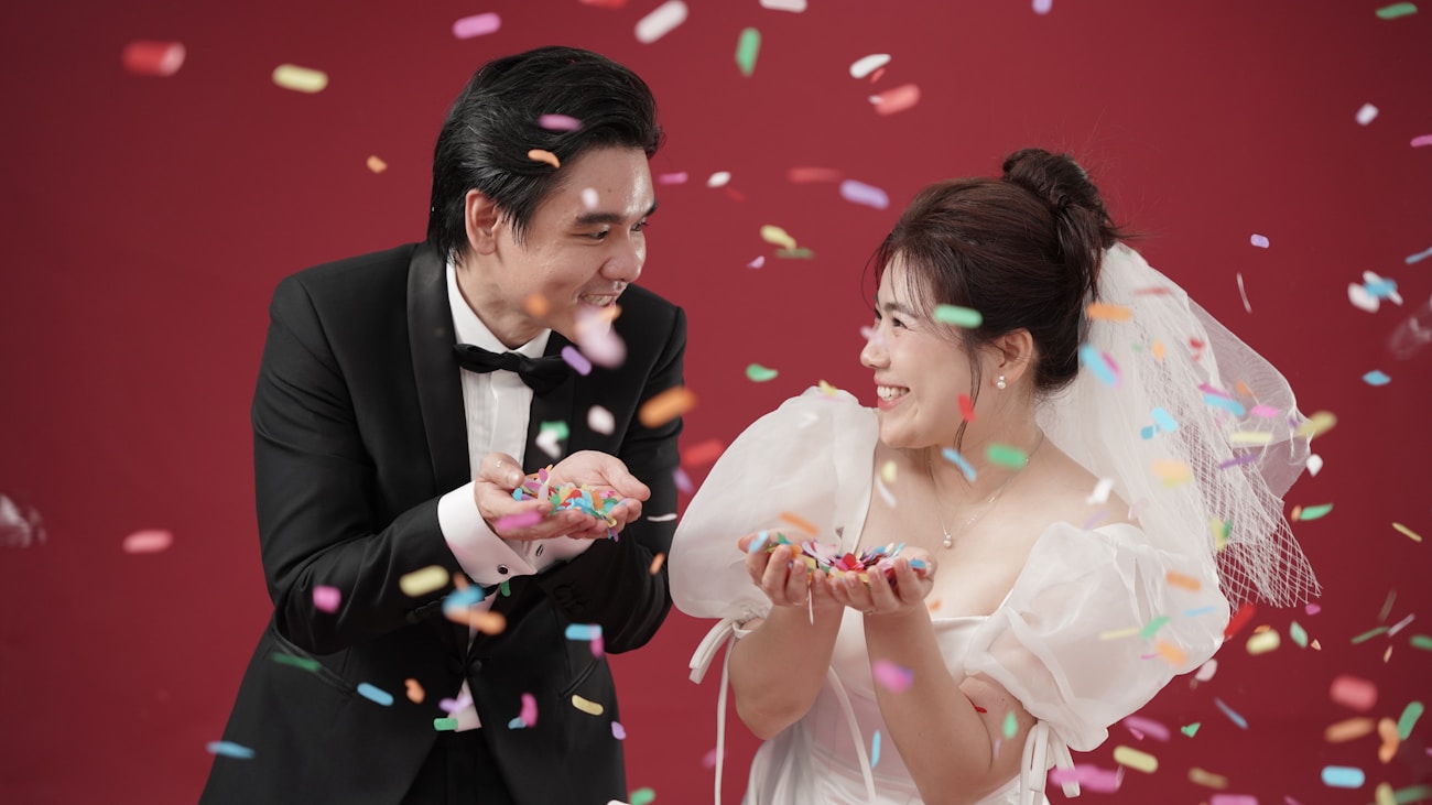 Bride and groom celebrating with confetti thrown in the air