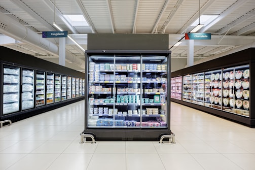 Refrigerated display cases in a supermarket aisle.
