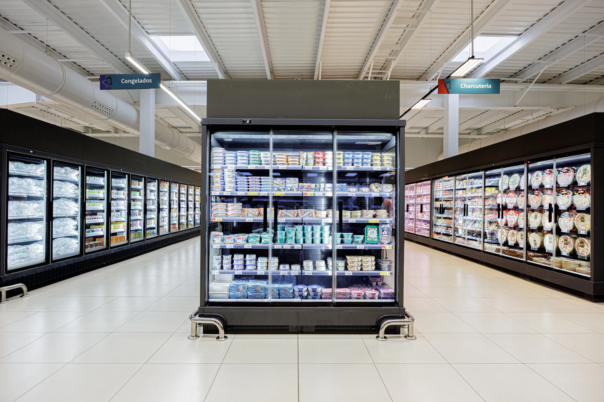 Refrigerated display cases in a supermarket aisle.