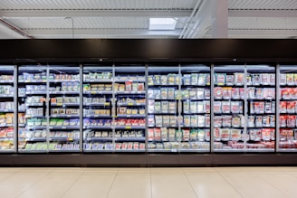 Refrigerated grocery store aisle with many products.