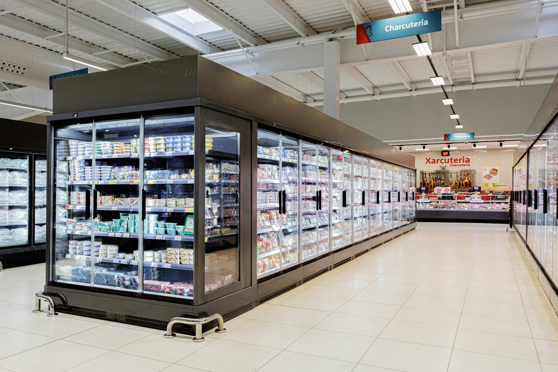 Refrigerated display cases filled with products in a store.