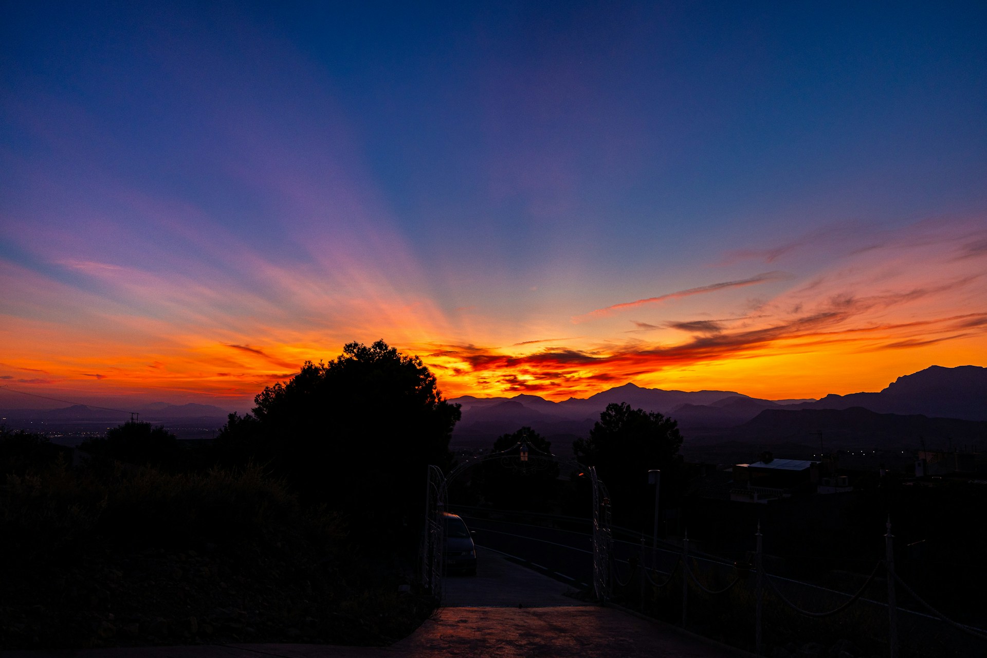 Dramatic sunset with vibrant colors over mountains.
