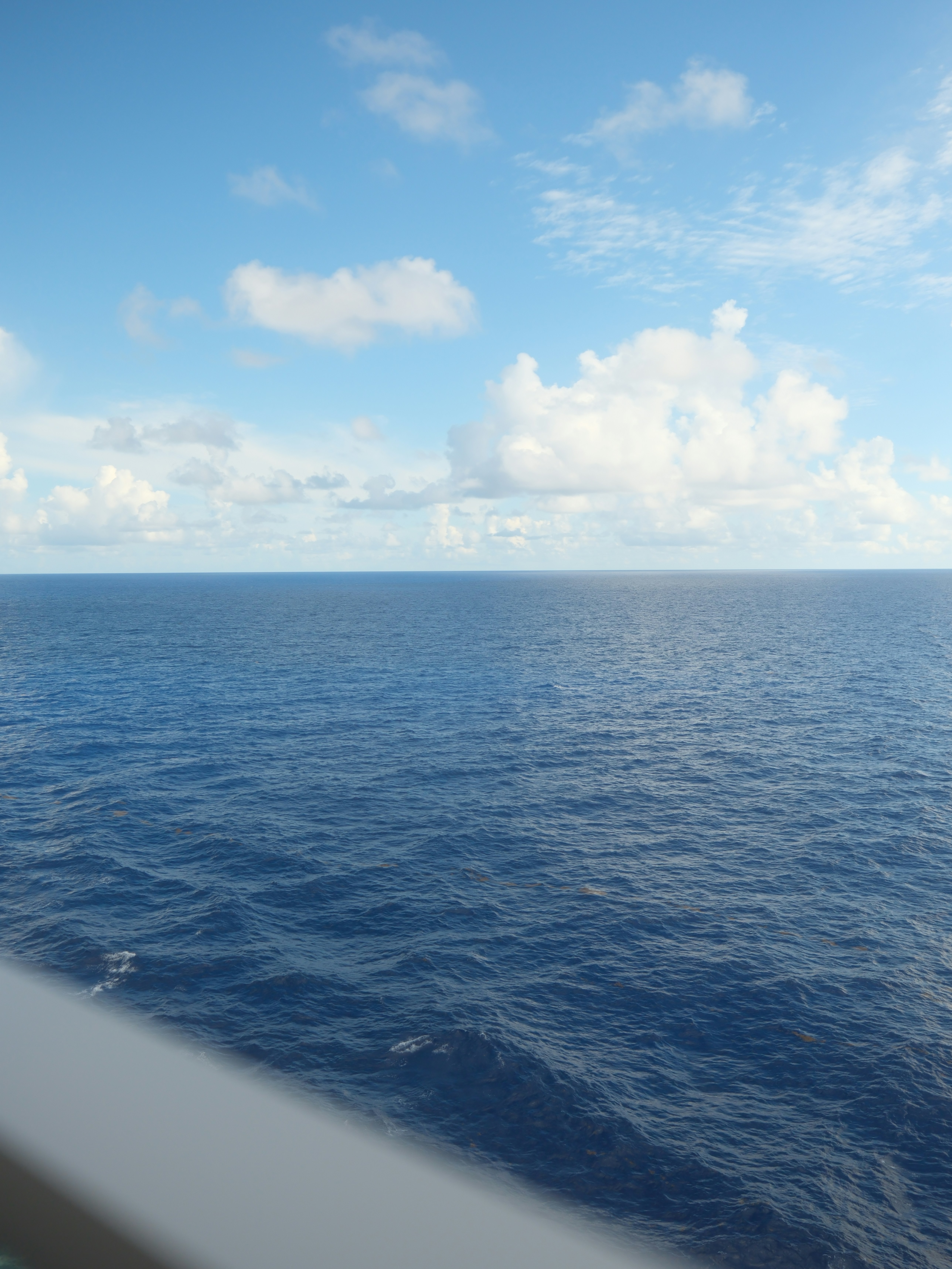 Calm blue ocean under a cloudy sky