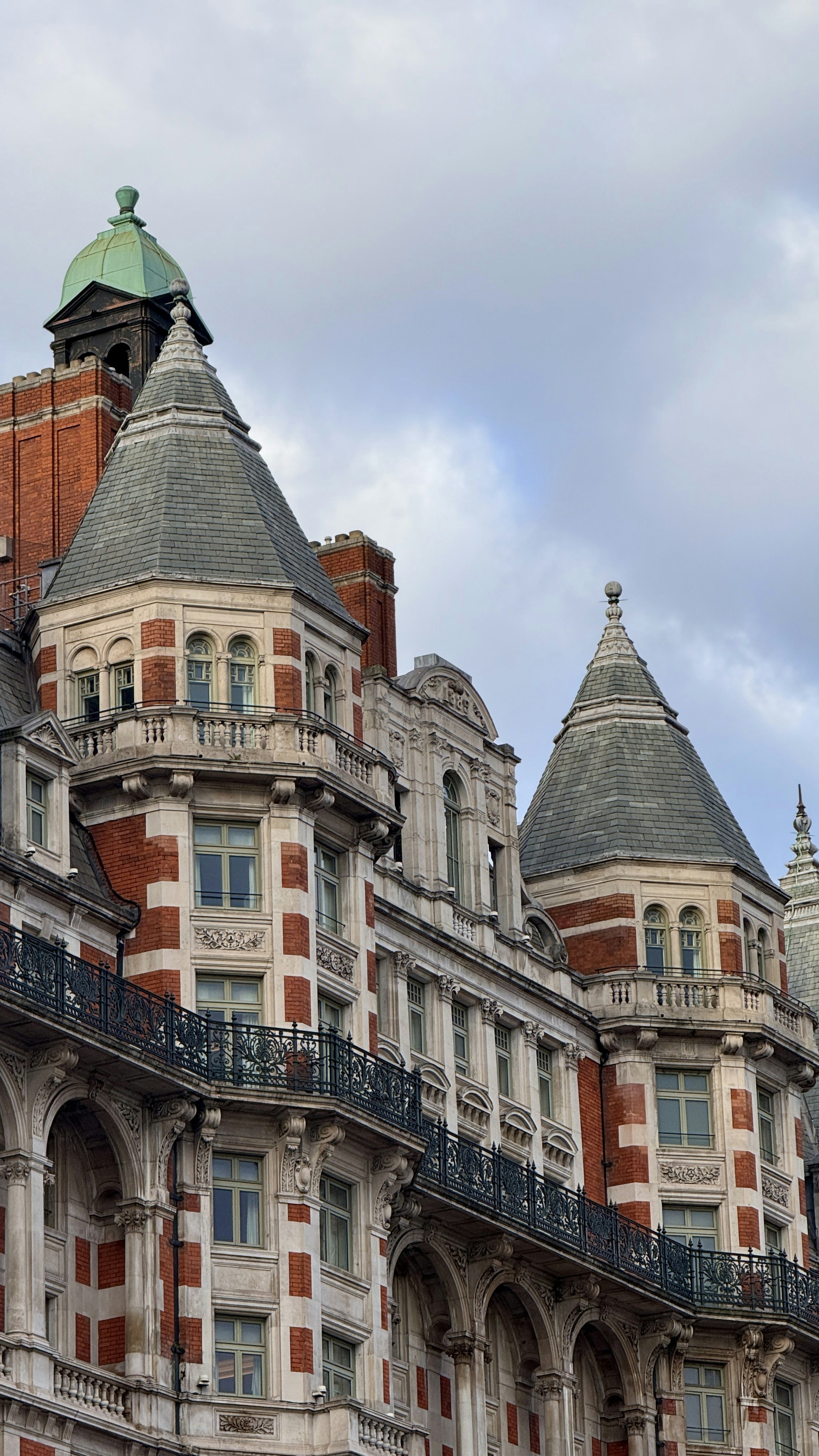 Ornate building with conical roofs and balconies