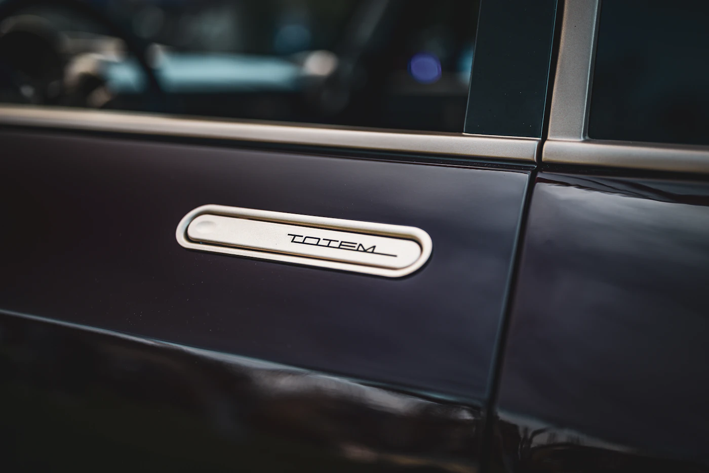 Dark car door with chrome trim detail