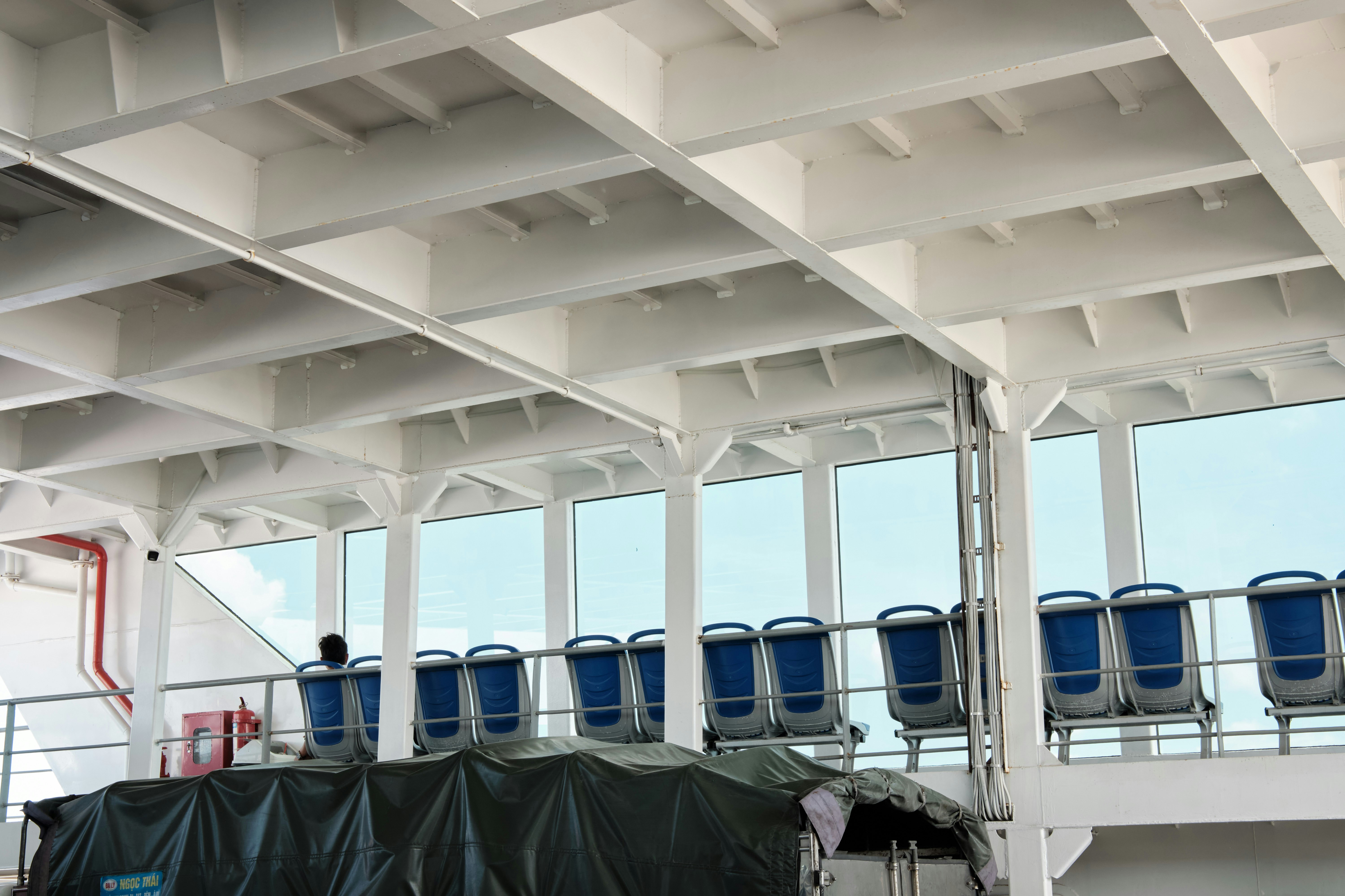 Rows of blue seats by windows on a ferry