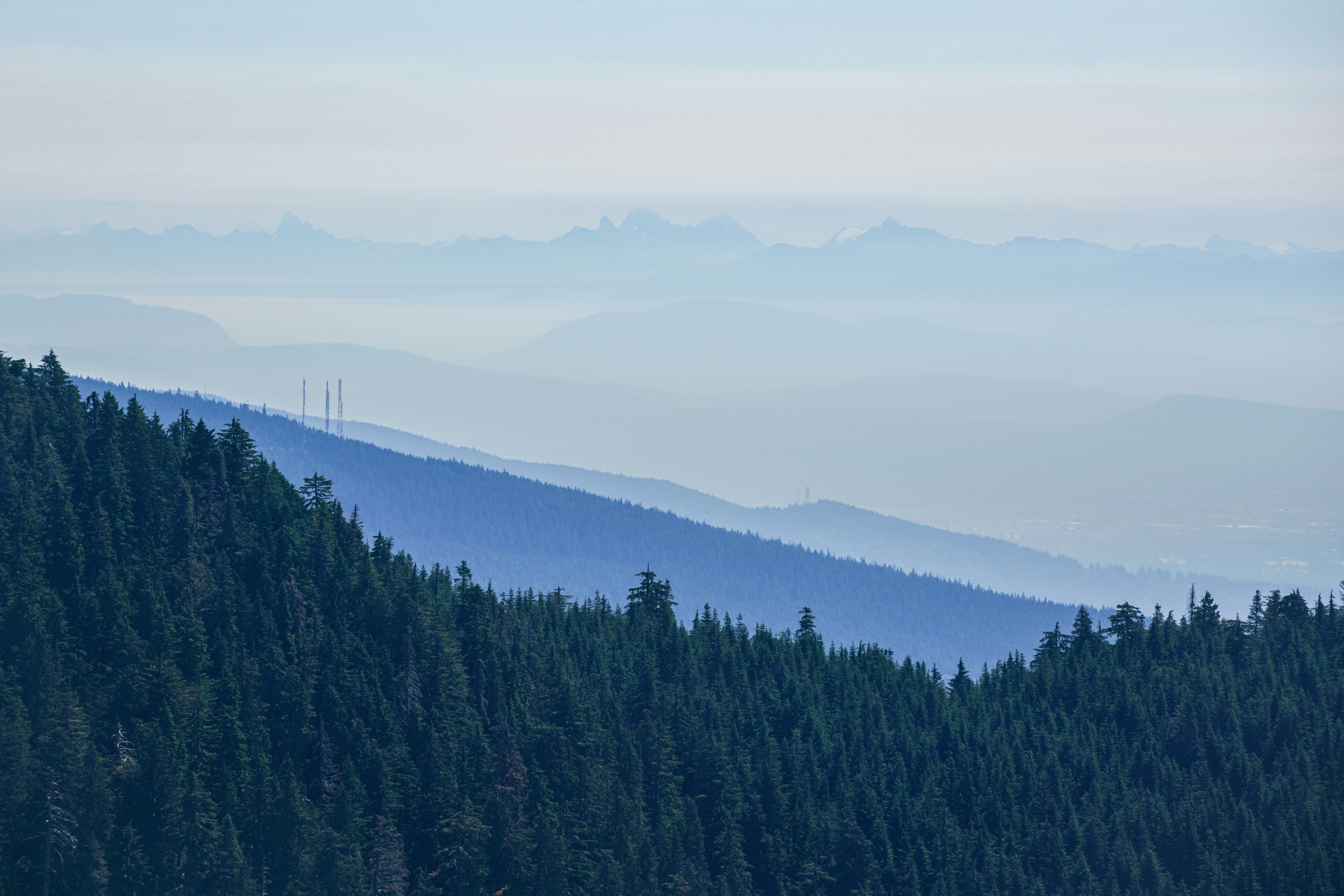 Ferne Berge verblassen in einem dunstigen blauen Himmel.