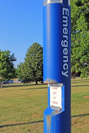 Blue emergency call box with "out of order" sign.