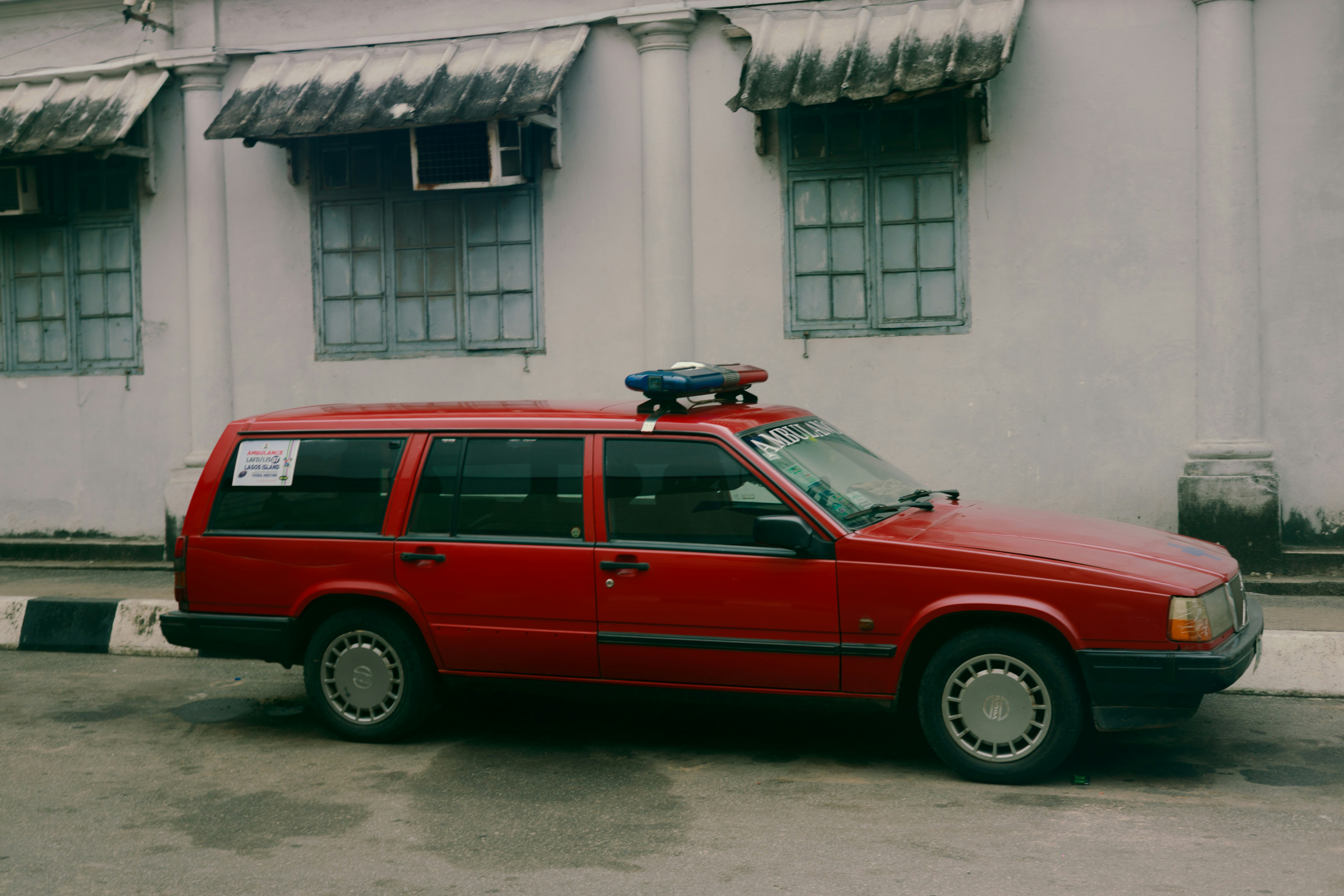 Red emergency vehicle parked near building